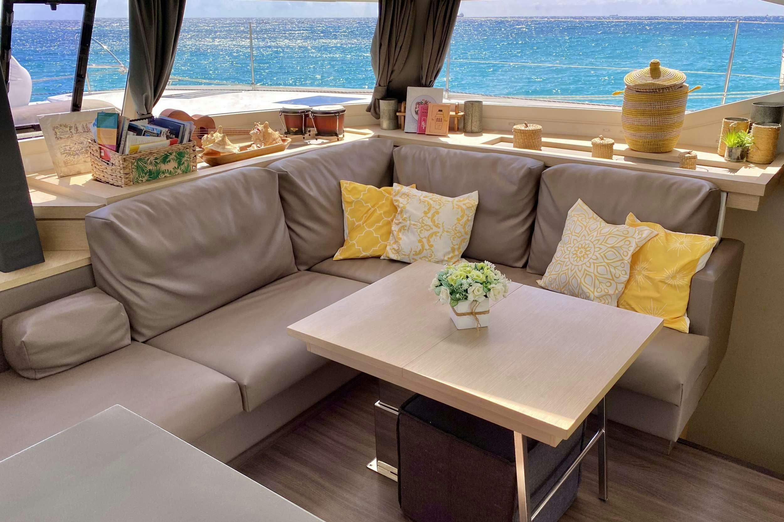 a couch with a table in front of it aboard BLACK TORTUGA Yacht for Charter