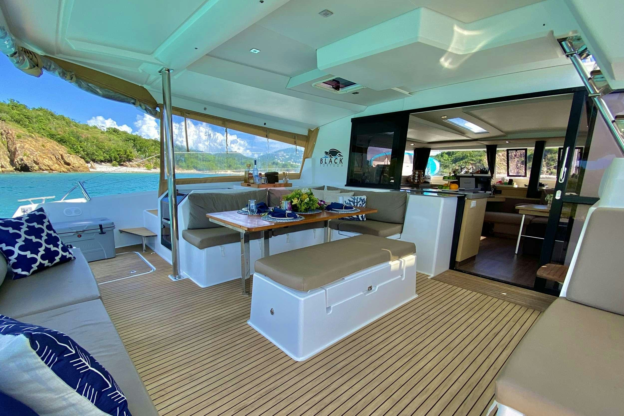 a living room with a large pool aboard BLACK TORTUGA Yacht for Charter