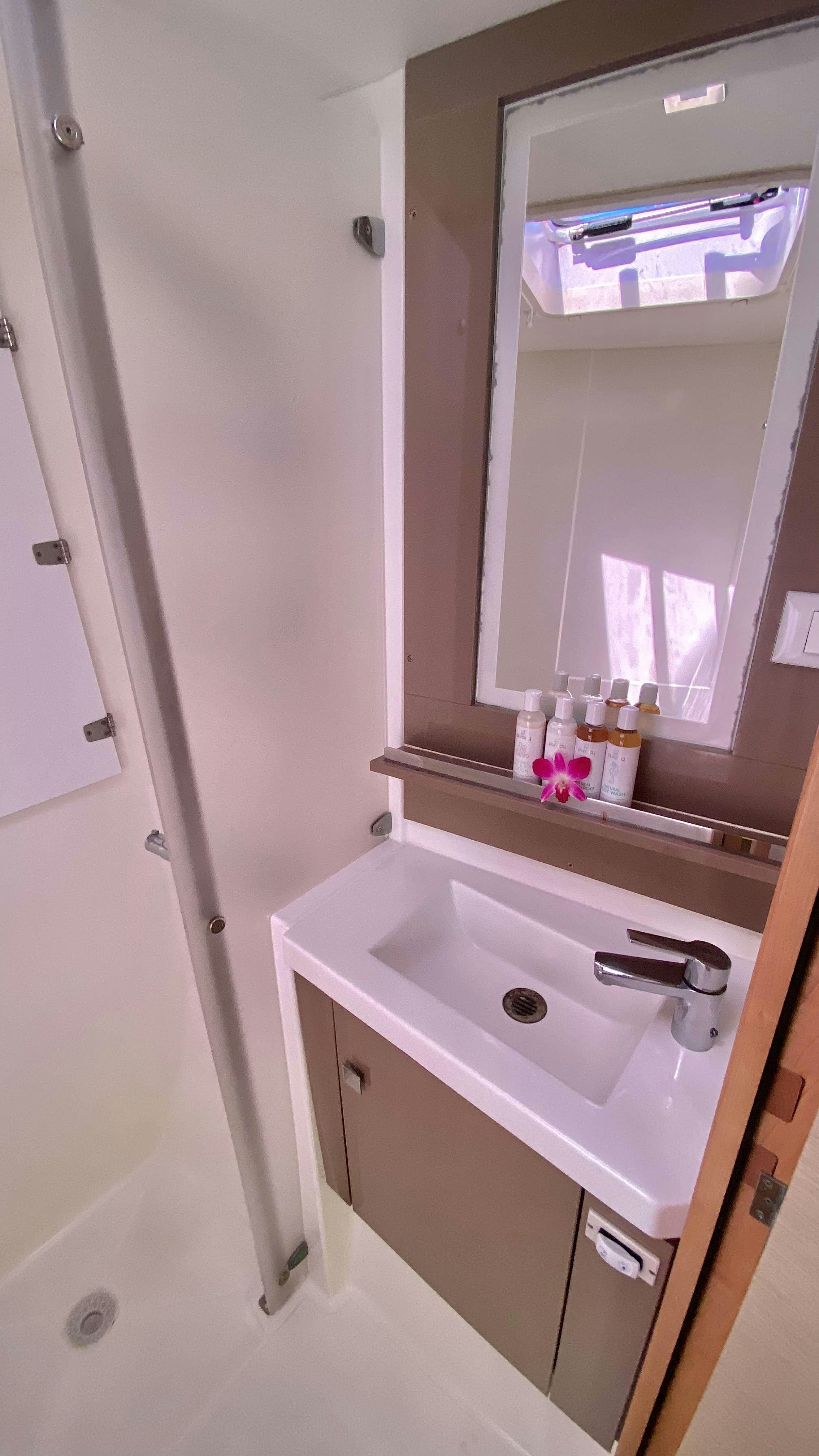 a bathroom with a sink and a mirror aboard BLACK TORTUGA Yacht for Charter