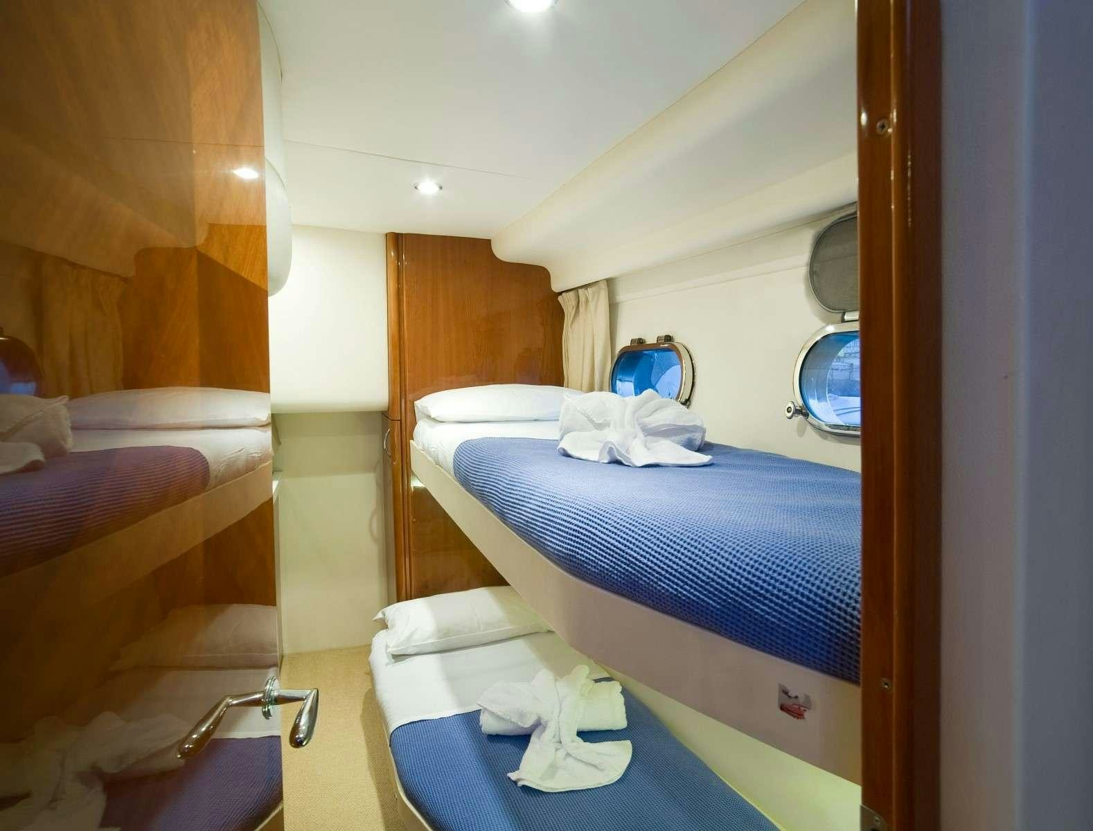 a room with a couple beds aboard FAST BREAK Yacht for Charter