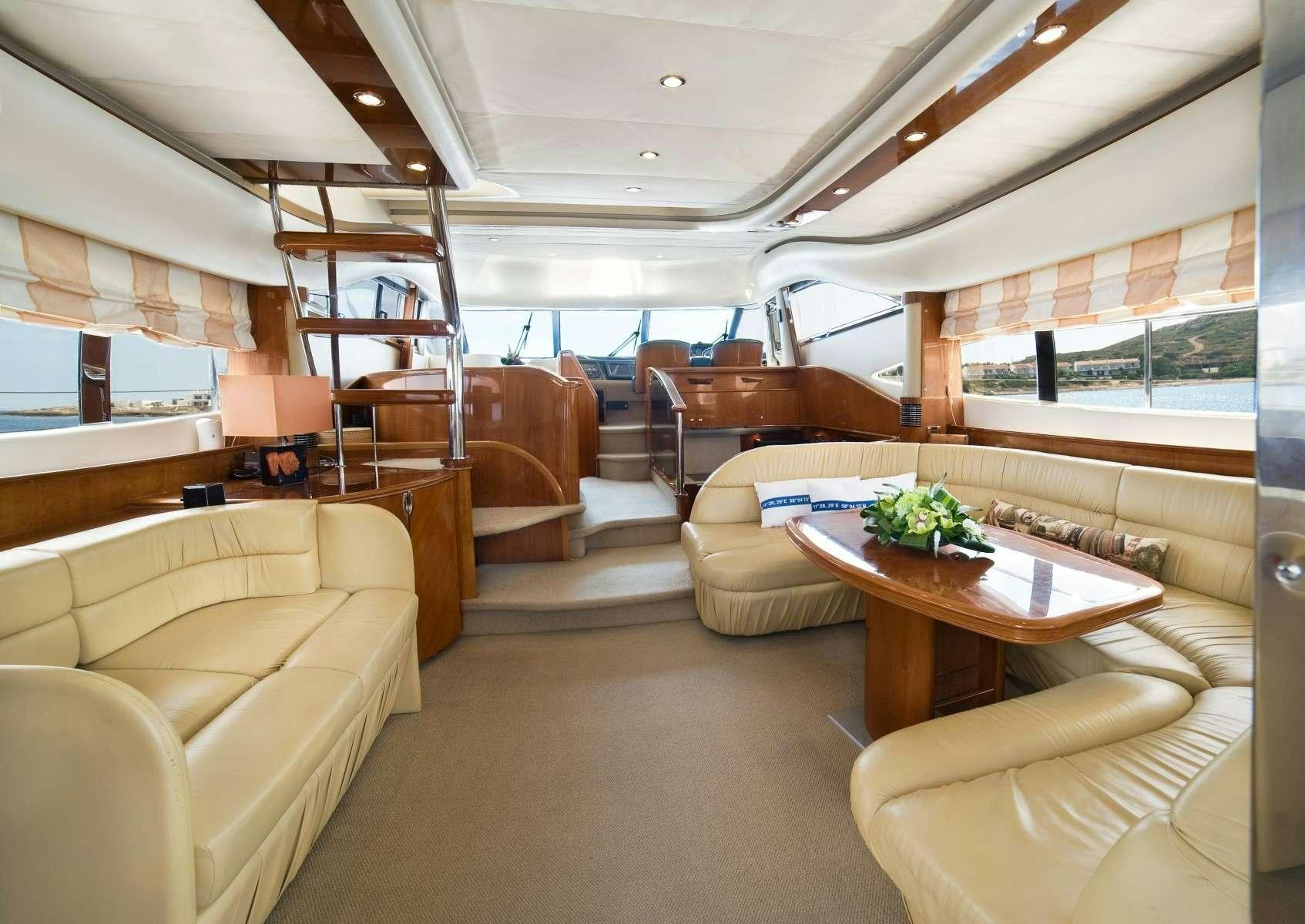 a room with couches and a table aboard FAST BREAK Yacht for Charter