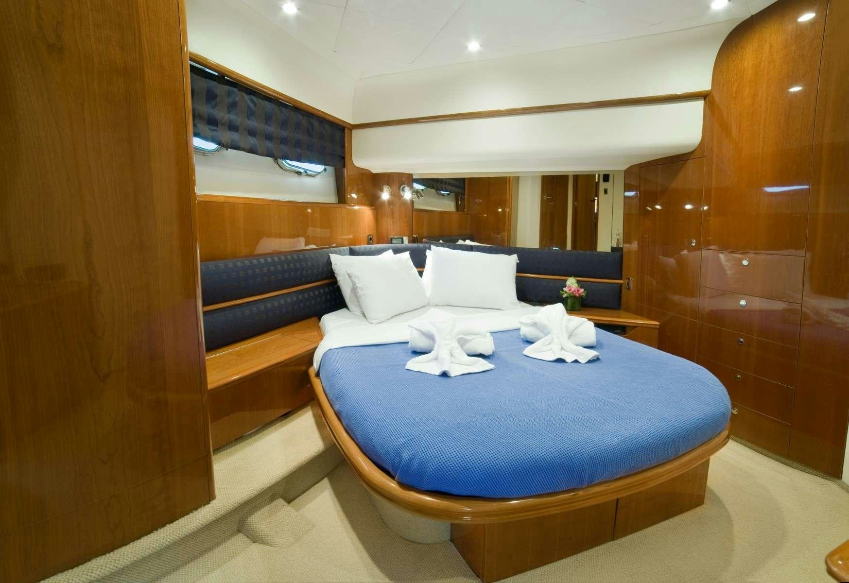 a bed with a blue bed aboard FAST BREAK Yacht for Charter