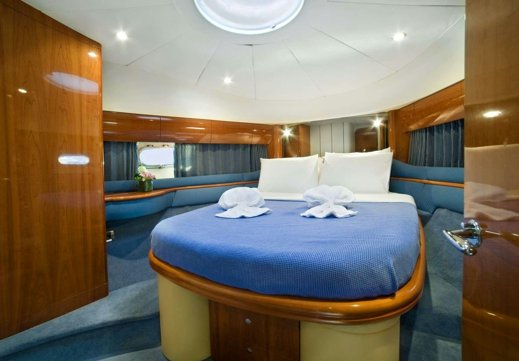 a bed with blue sheets aboard FAST BREAK Yacht for Charter