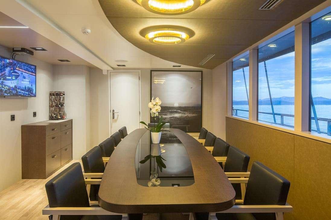 a room with a table and chairs aboard RARA AVIS Yacht for Charter
