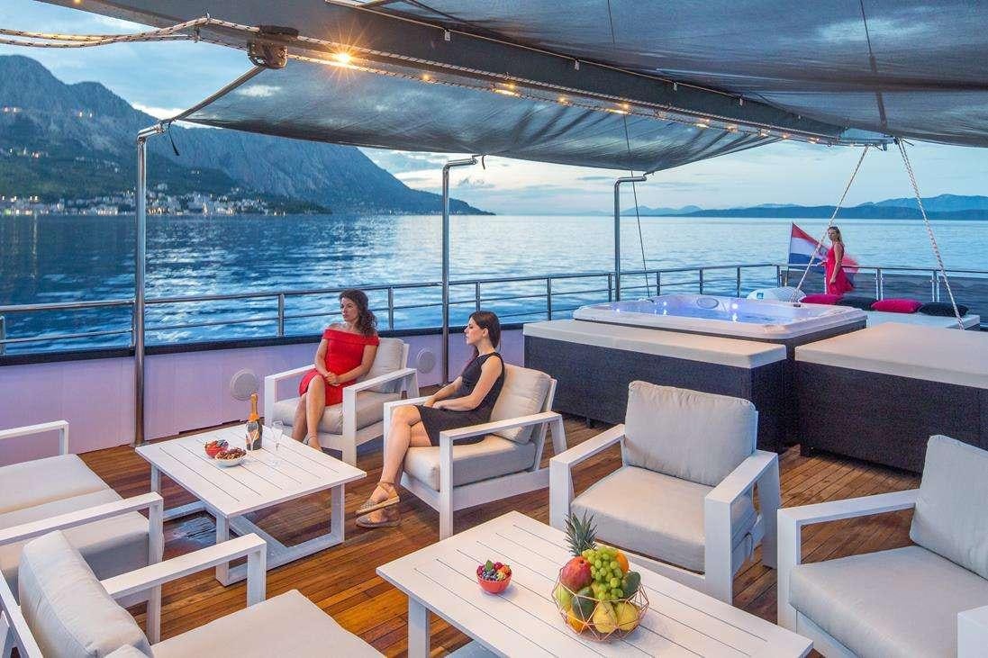 a couple sitting on a boat aboard RARA AVIS Yacht for Charter