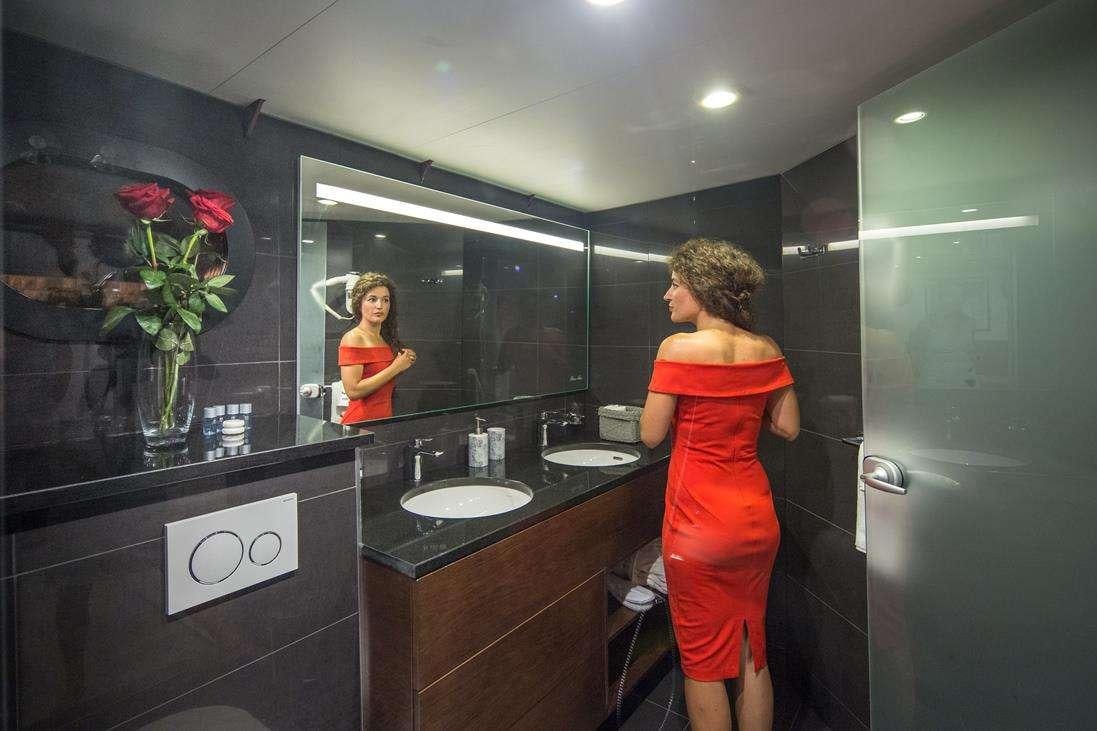 a person in a bathroom aboard RARA AVIS Yacht for Charter