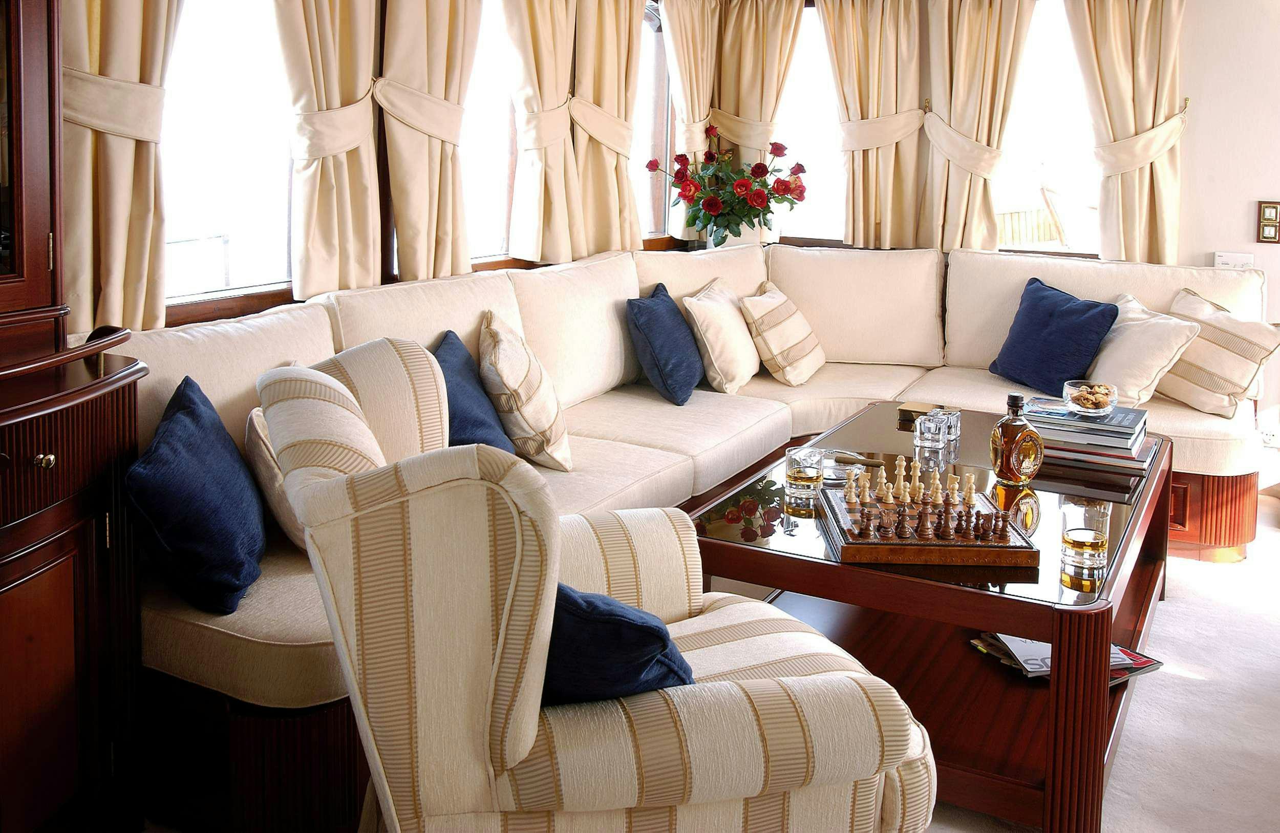 a living room with white couches and a coffee table aboard LIANA H Yacht for Charter