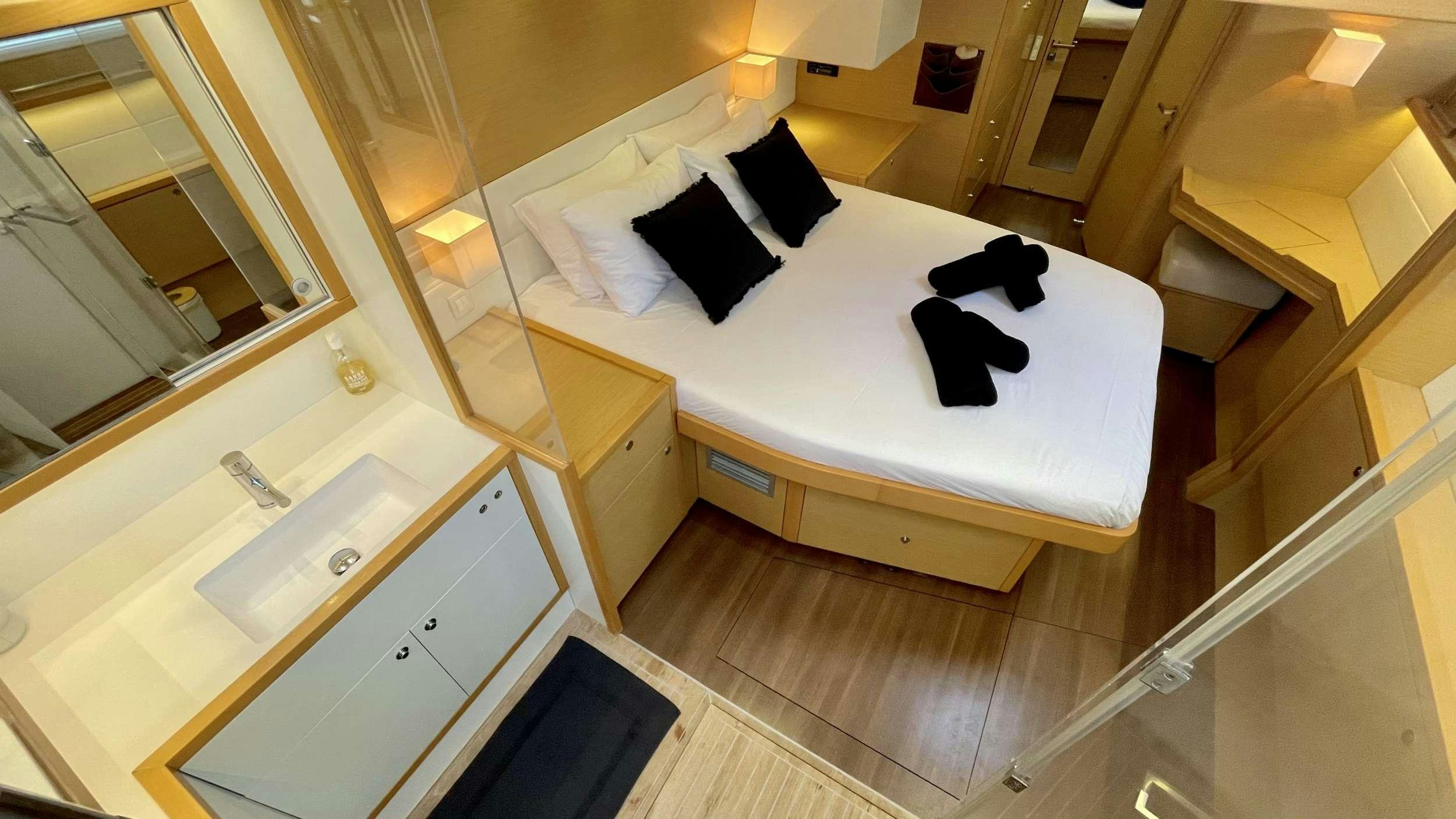 a bed with white sheets aboard ZYLKENE 1 Yacht for Charter