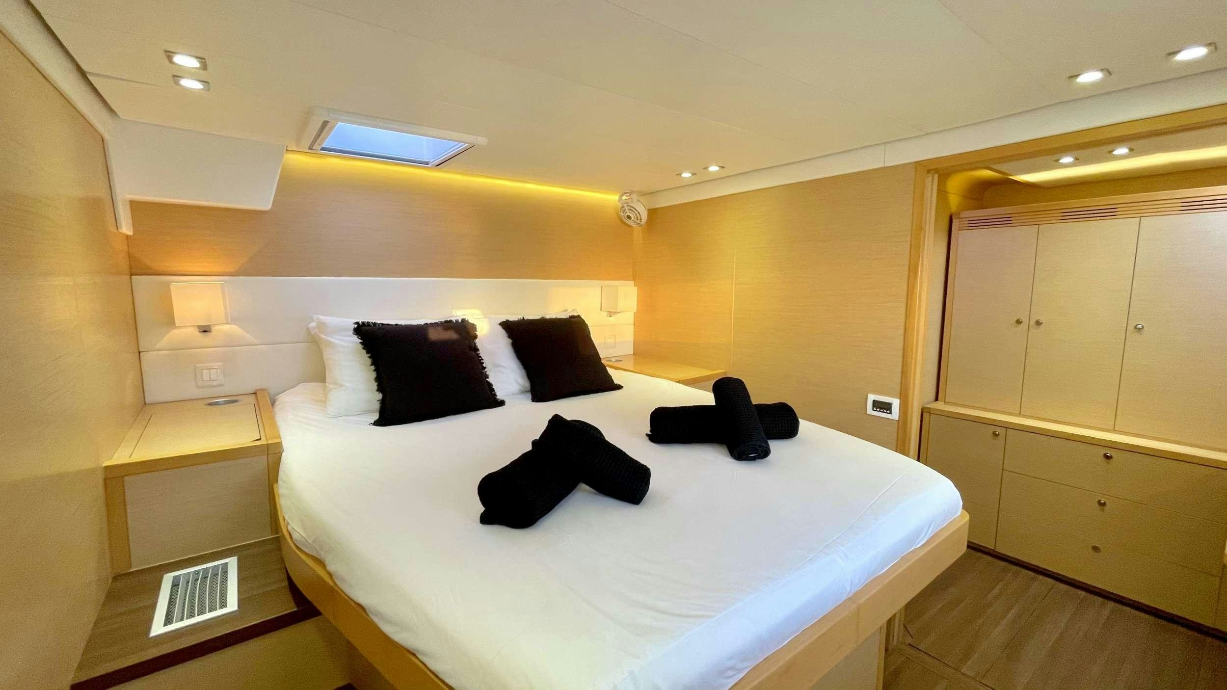 a room with a bed and a desk aboard ZYLKENE 1 Yacht for Charter