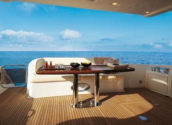 a table on a deck overlooking the ocean aboard EMMY Yacht for Charter