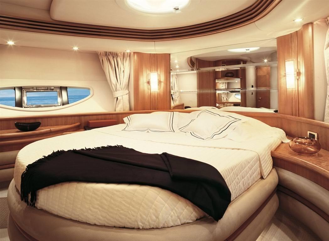a bed with a black and white bed spread aboard EMMY Yacht for Charter