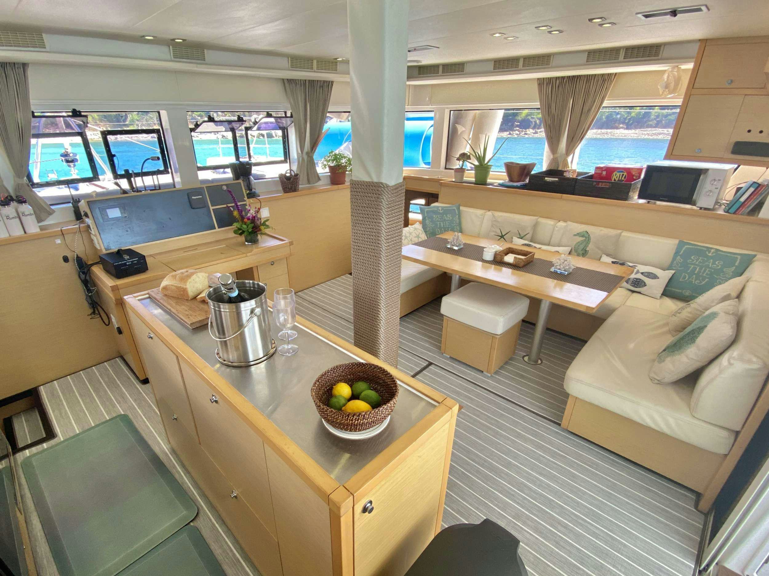 a room with a table and chairs aboard RUMBA Yacht for Charter