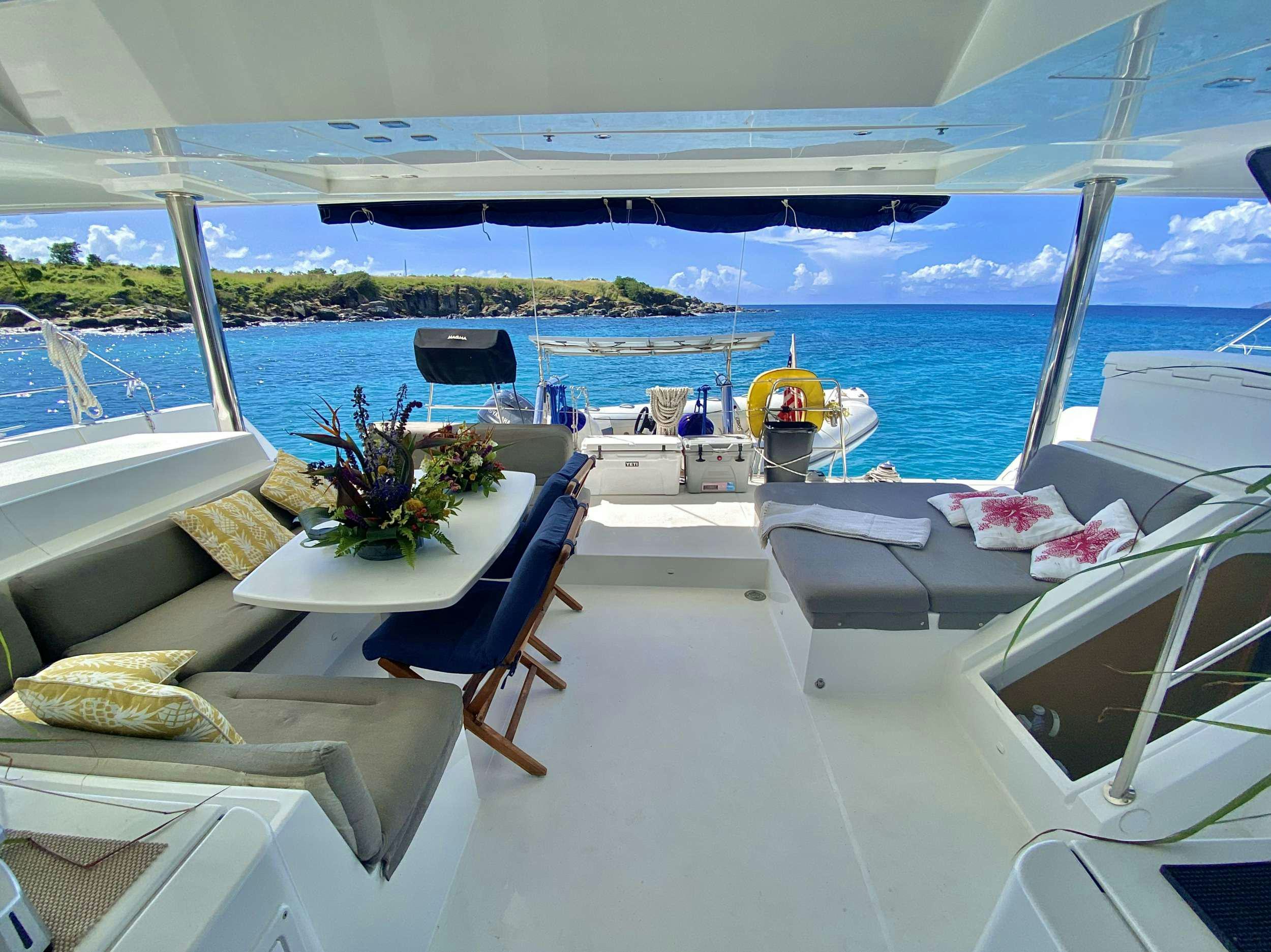 a boat with a table and chairs on it aboard RUMBA Yacht for Charter