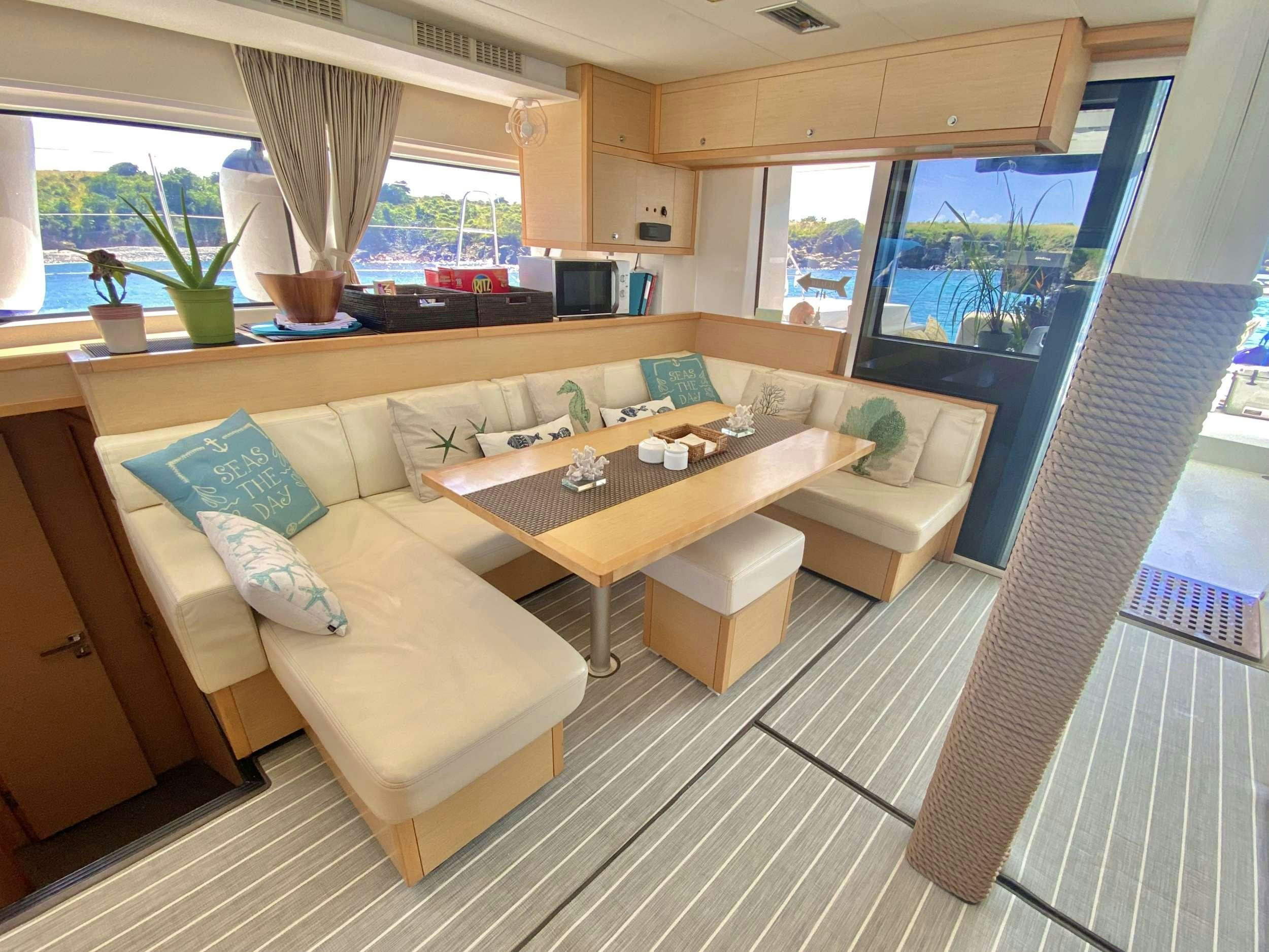 a living room with a couch and a table aboard RUMBA Yacht for Charter