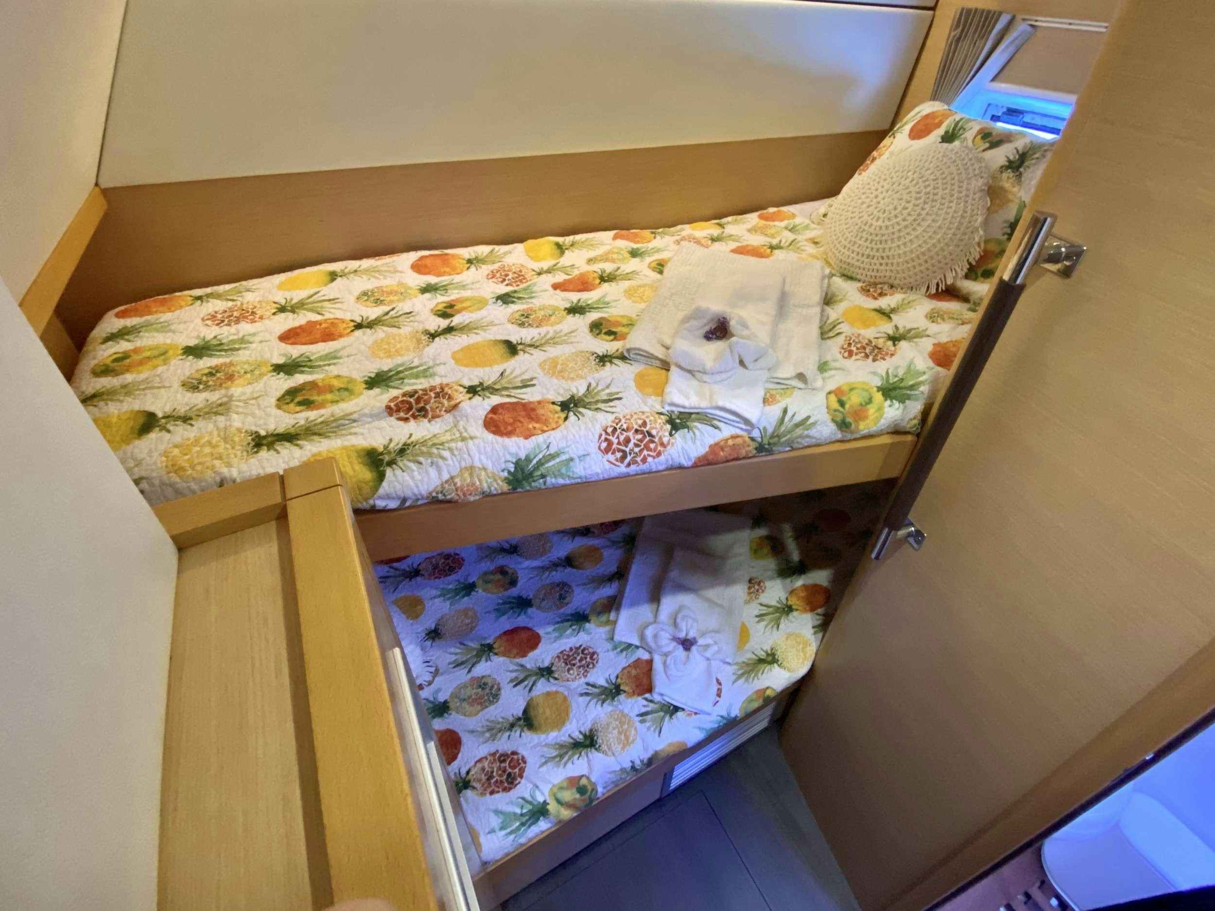 a couple of beds in a room aboard RUMBA Yacht for Charter