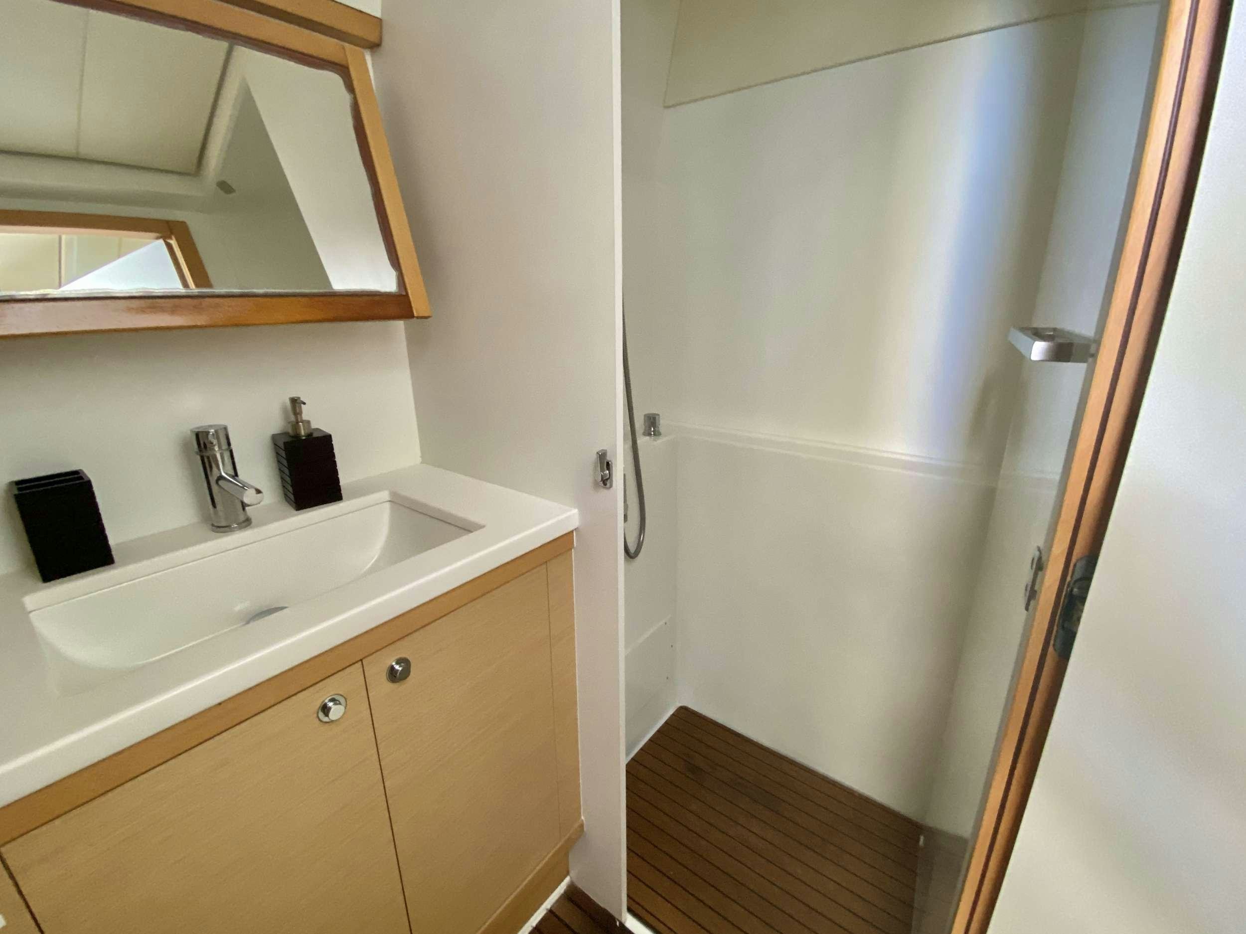 a bathroom with a sink and a mirror aboard RUMBA Yacht for Charter