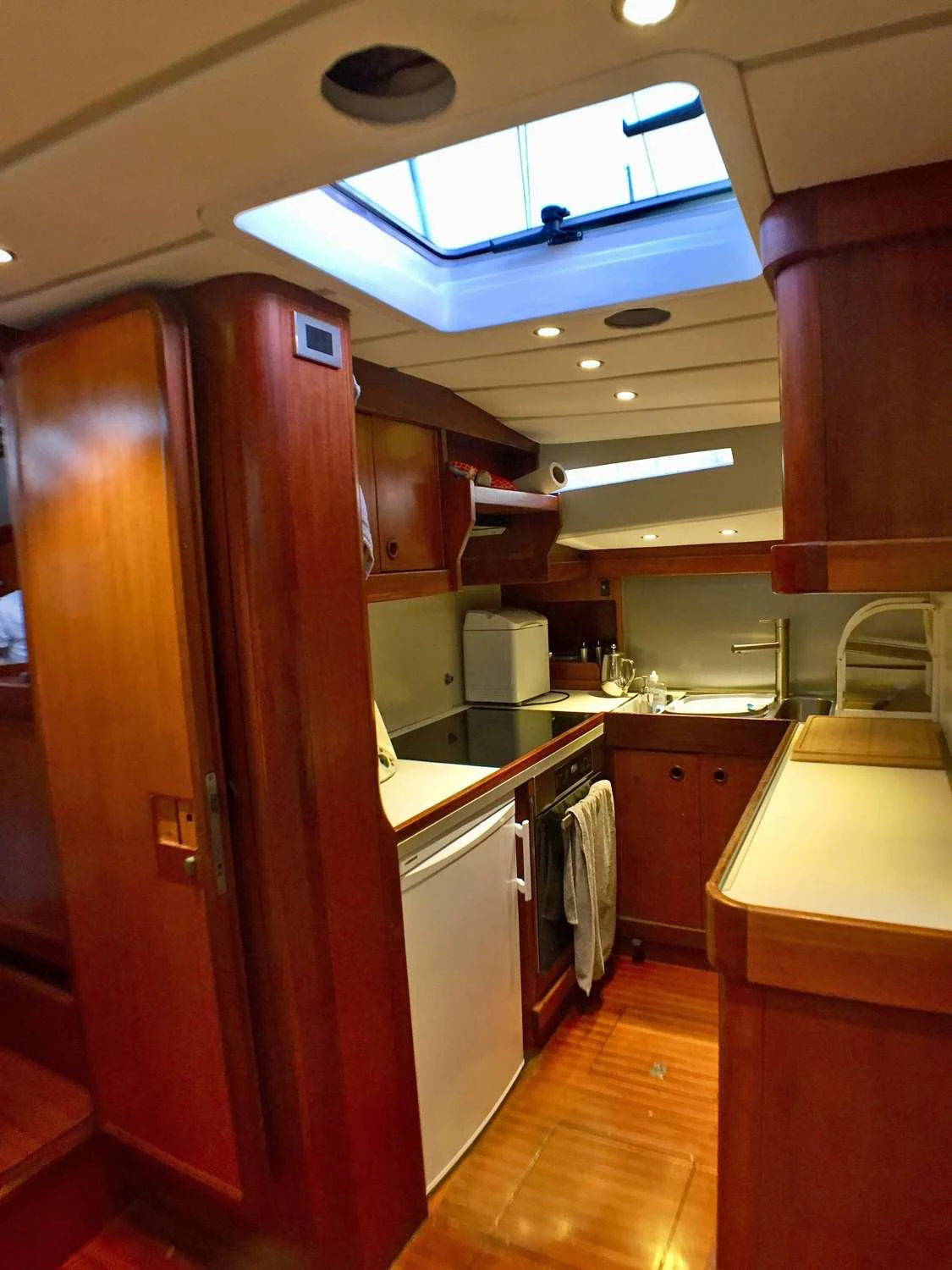 a kitchen with wooden cabinets aboard Bellacha Yacht for Charter