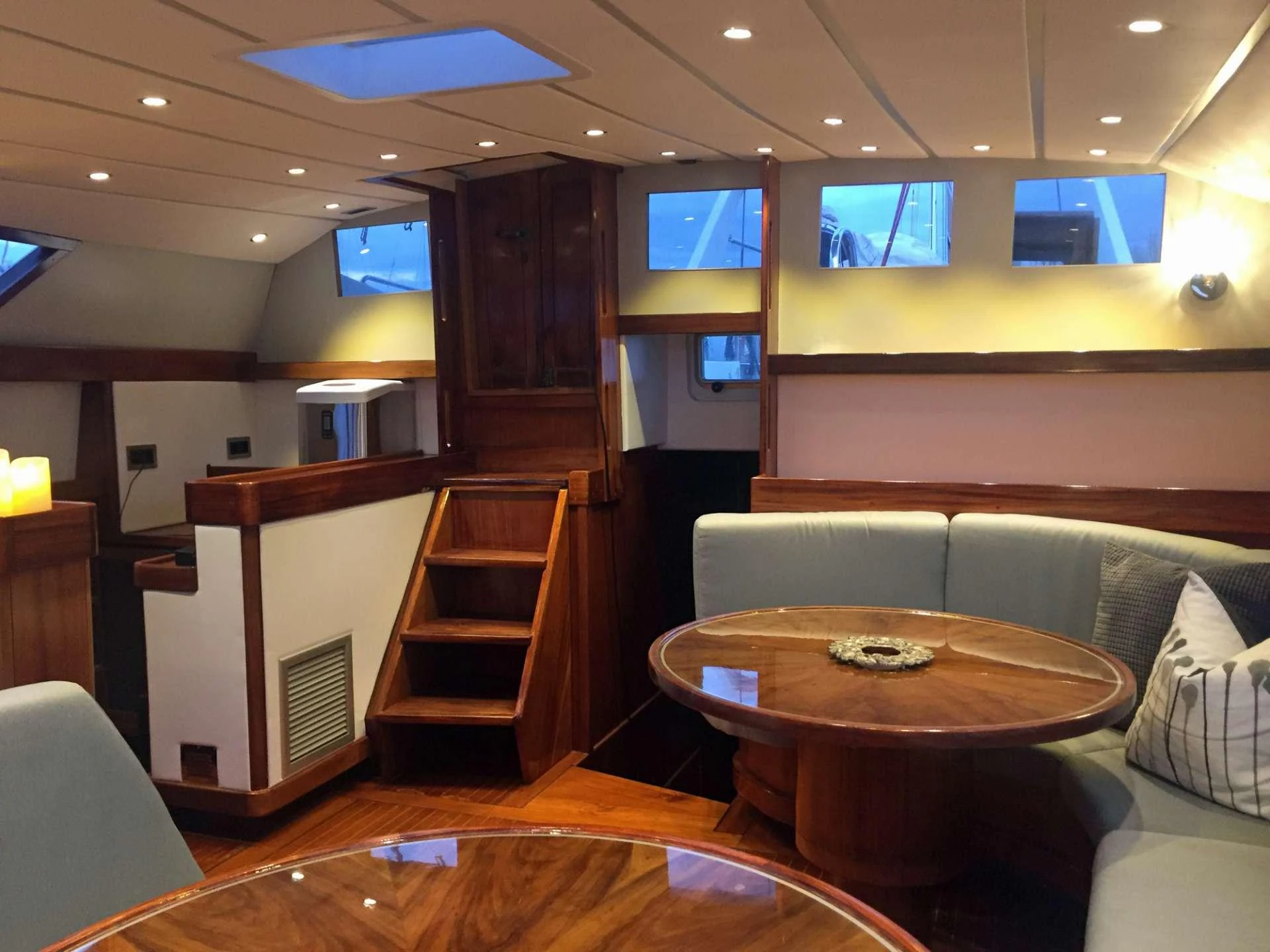 a living room with a staircase and a table aboard Bellacha Yacht for Charter