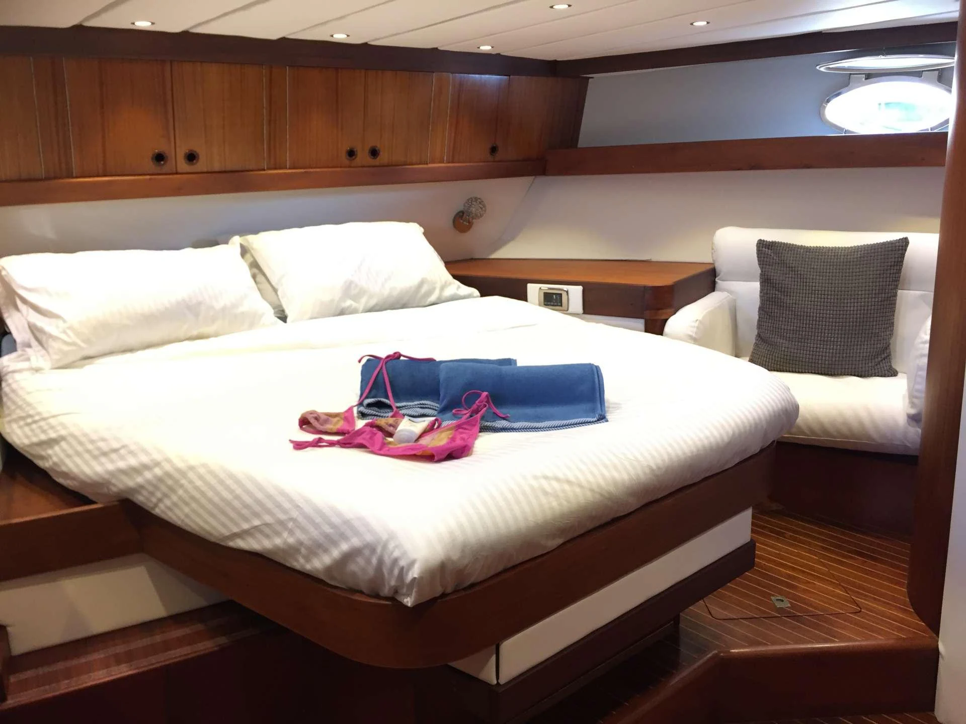 a bed with a blue blanket aboard Bellacha Yacht for Charter
