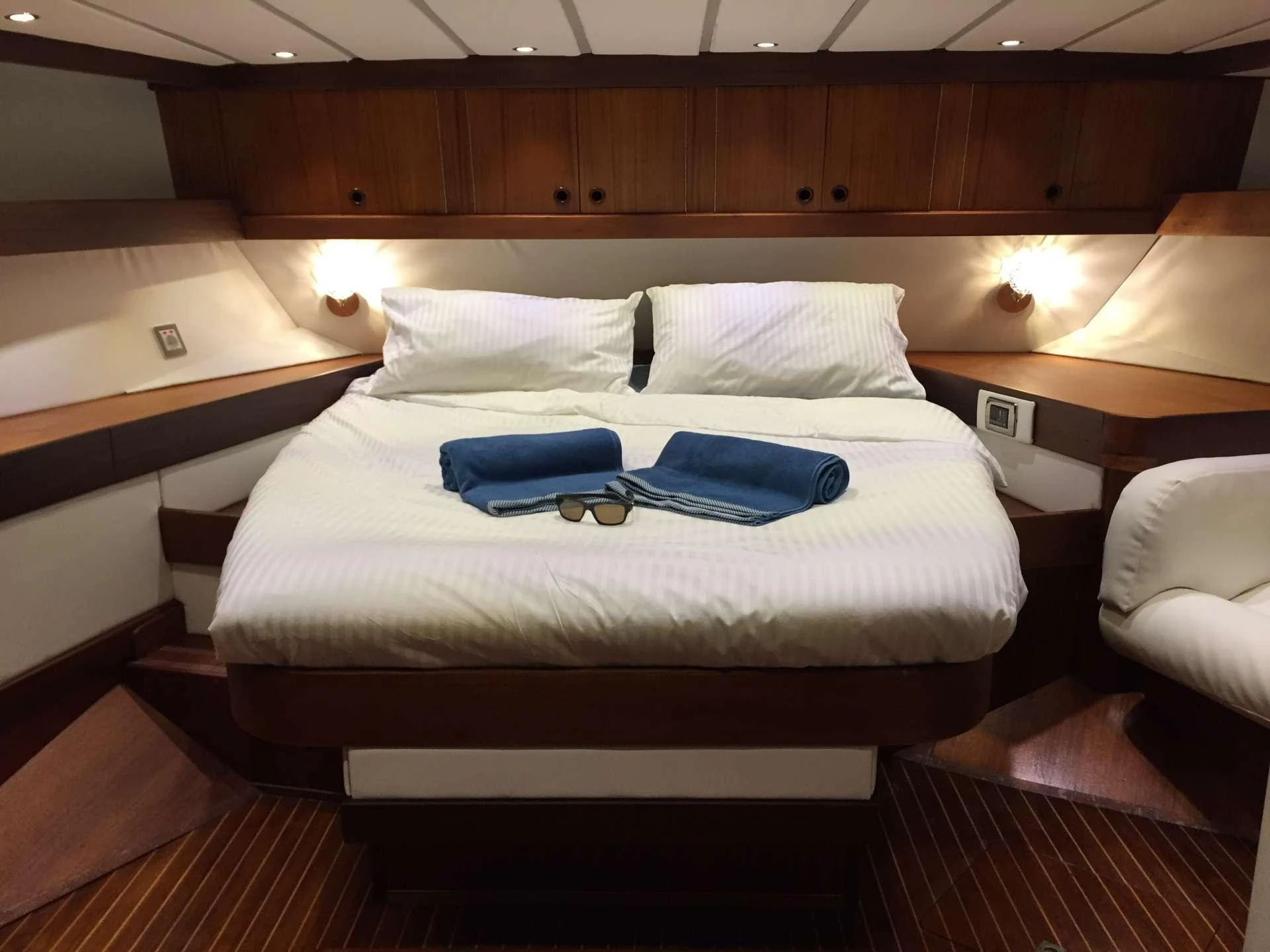a bed with a blue pillow aboard Bellacha Yacht for Charter