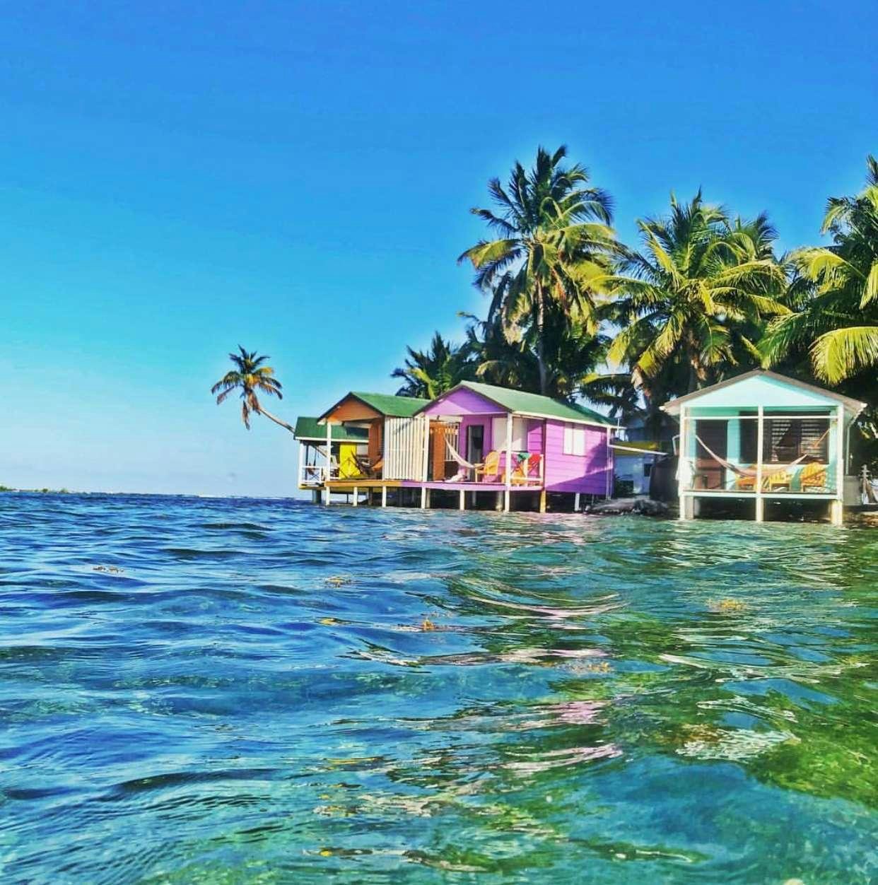 a row of houses on stilts on the water aboard LUNA SEA Yacht for Charter