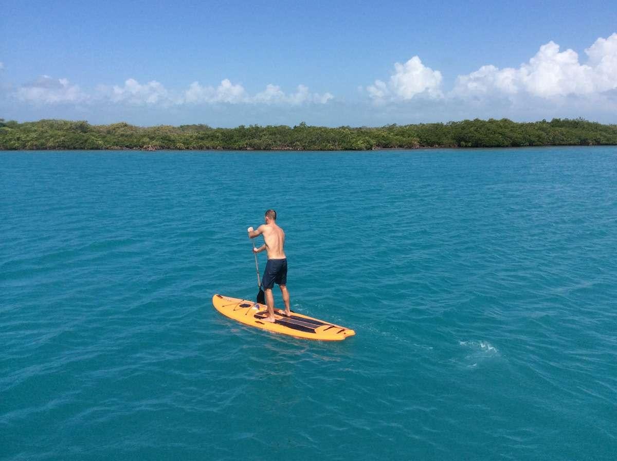 a person on a paddle board in the water aboard LUNA SEA Yacht for Charter