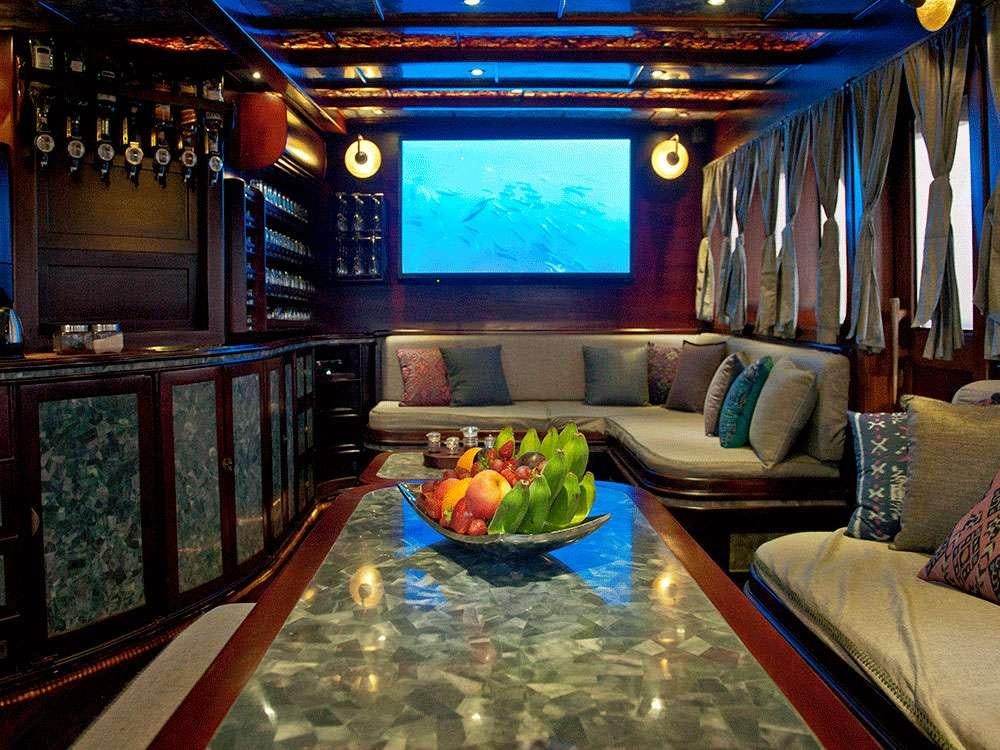 a living room with a table and couches aboard MANTAMAE Yacht for Charter