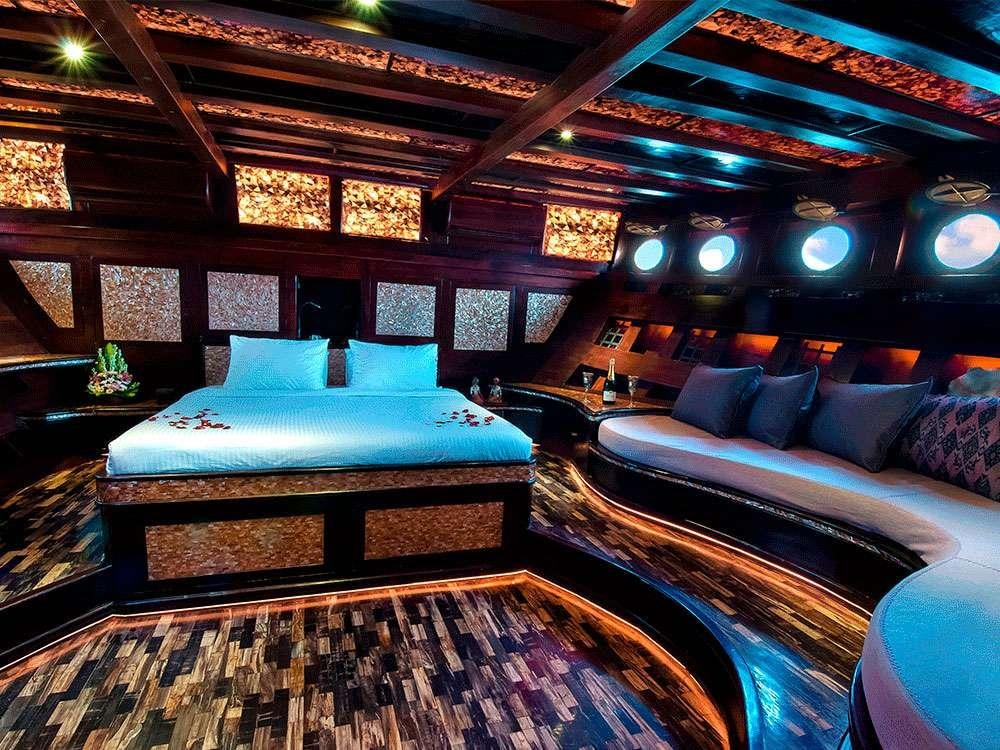 a room with a bed and a couch aboard MANTAMAE Yacht for Charter