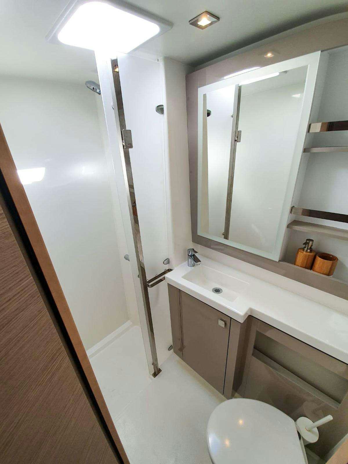 a bathroom with a shower and sink aboard CHAMPS ELYSEES Yacht for Charter