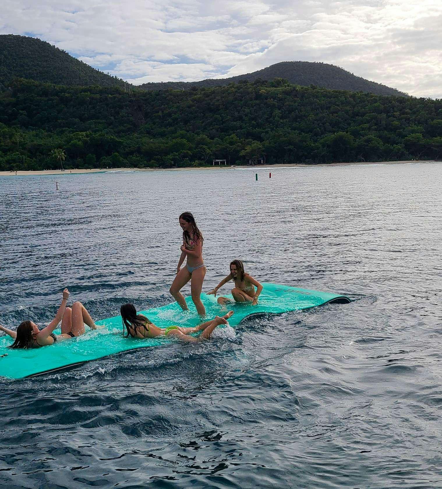 a group of people on a beach aboard CHAMPS ELYSEES Yacht for Charter