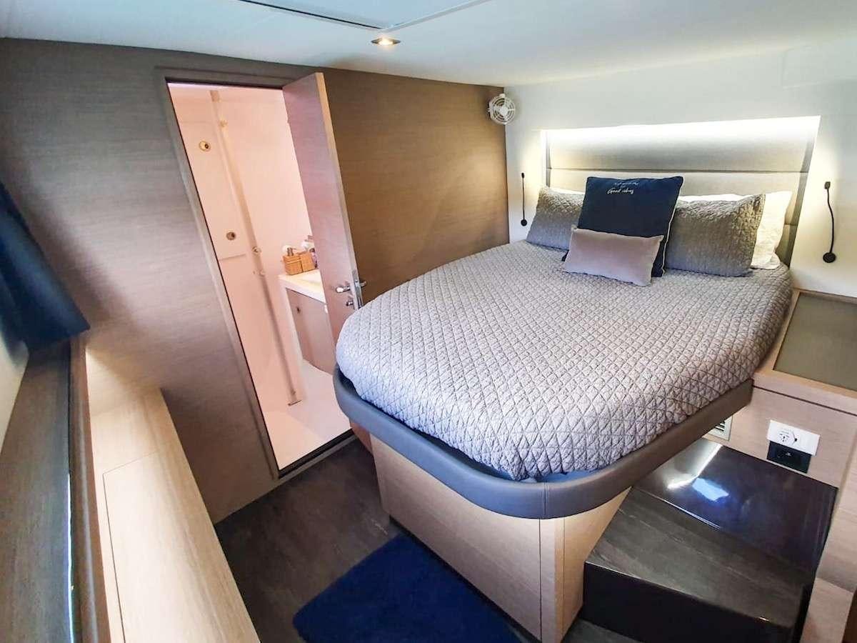 a bed with a white sheet aboard CHAMPS ELYSEES Yacht for Charter