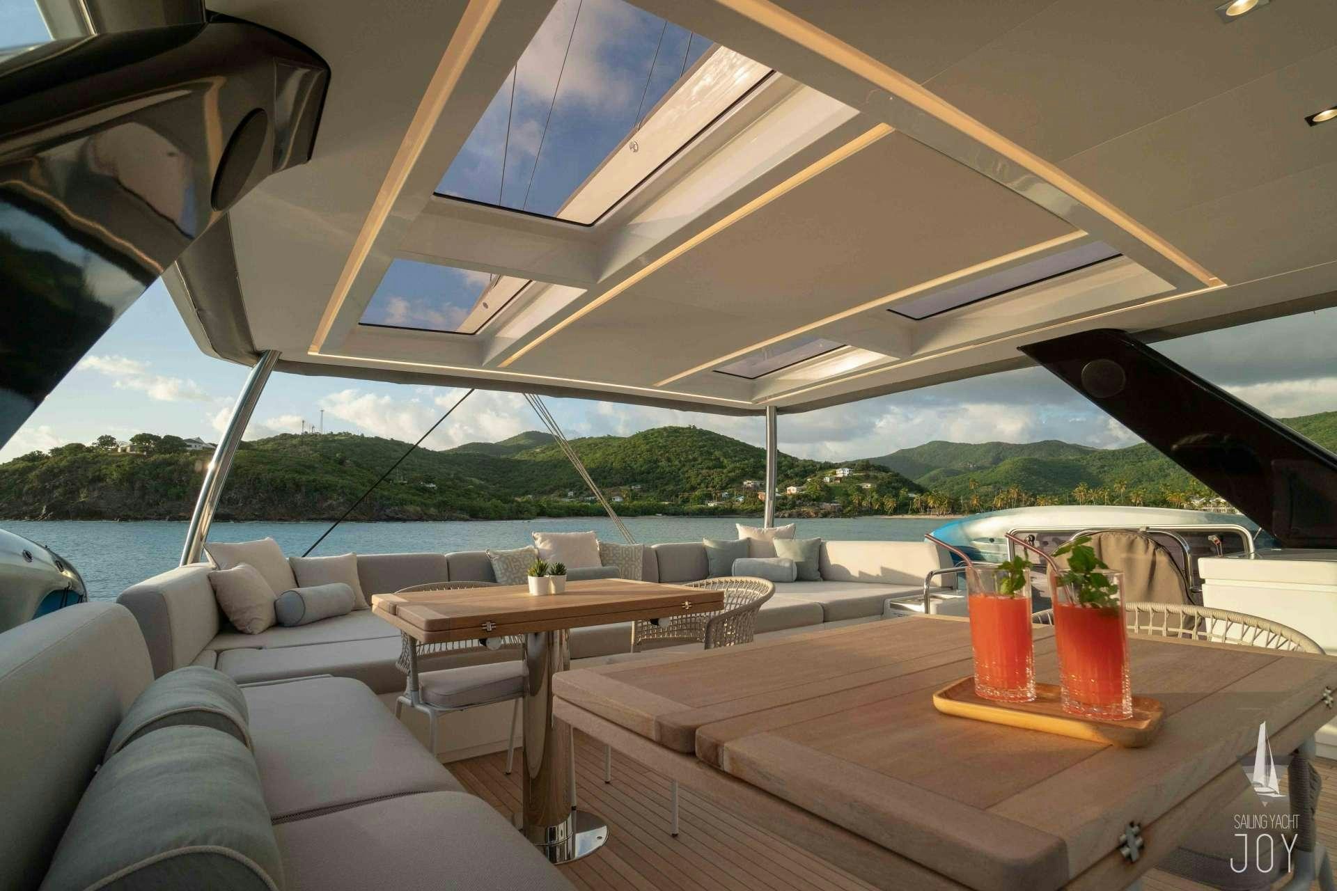 a room with a table and chairs aboard JOY Yacht for Charter