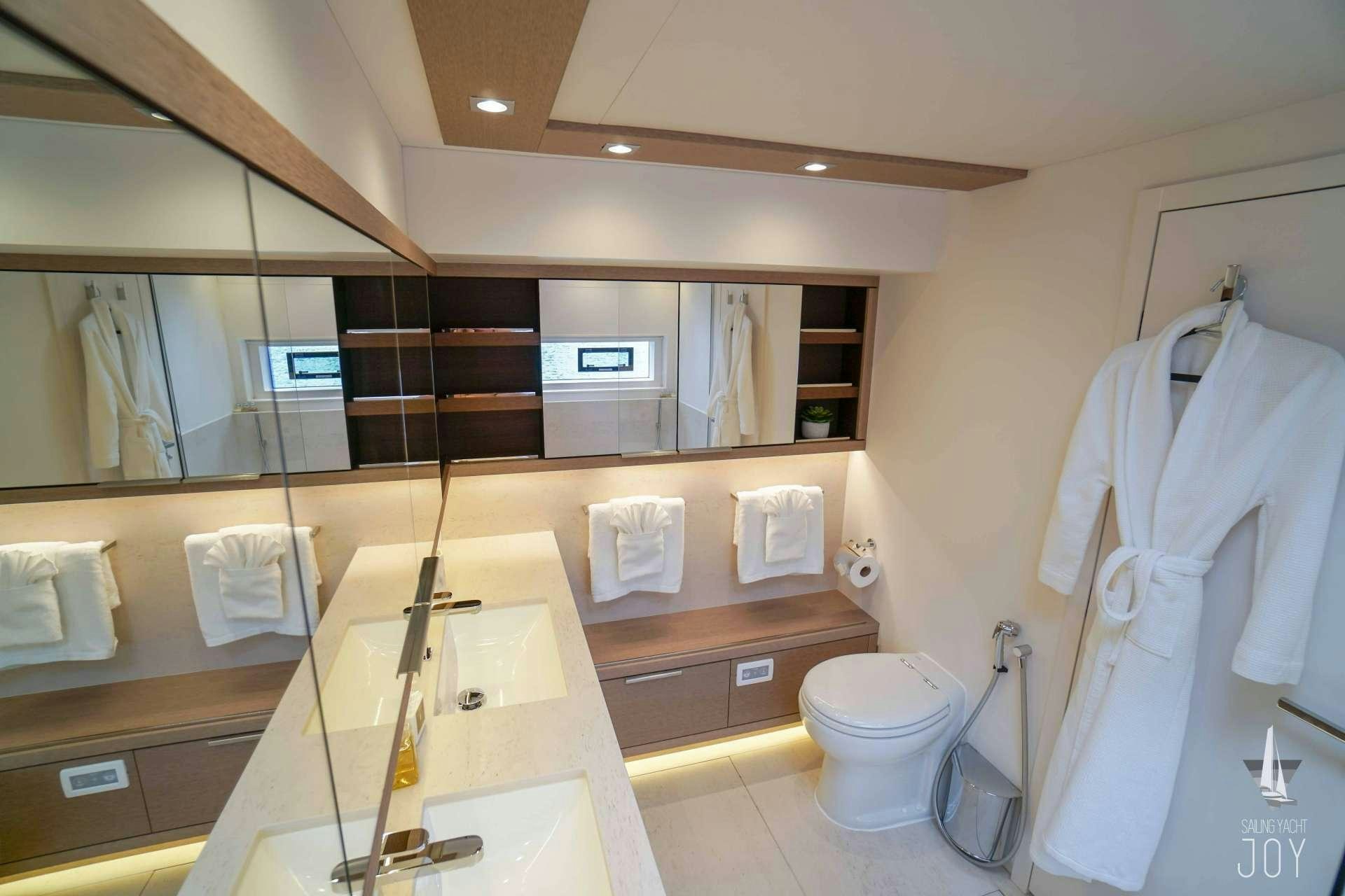a bathroom with a large mirror aboard JOY Yacht for Charter