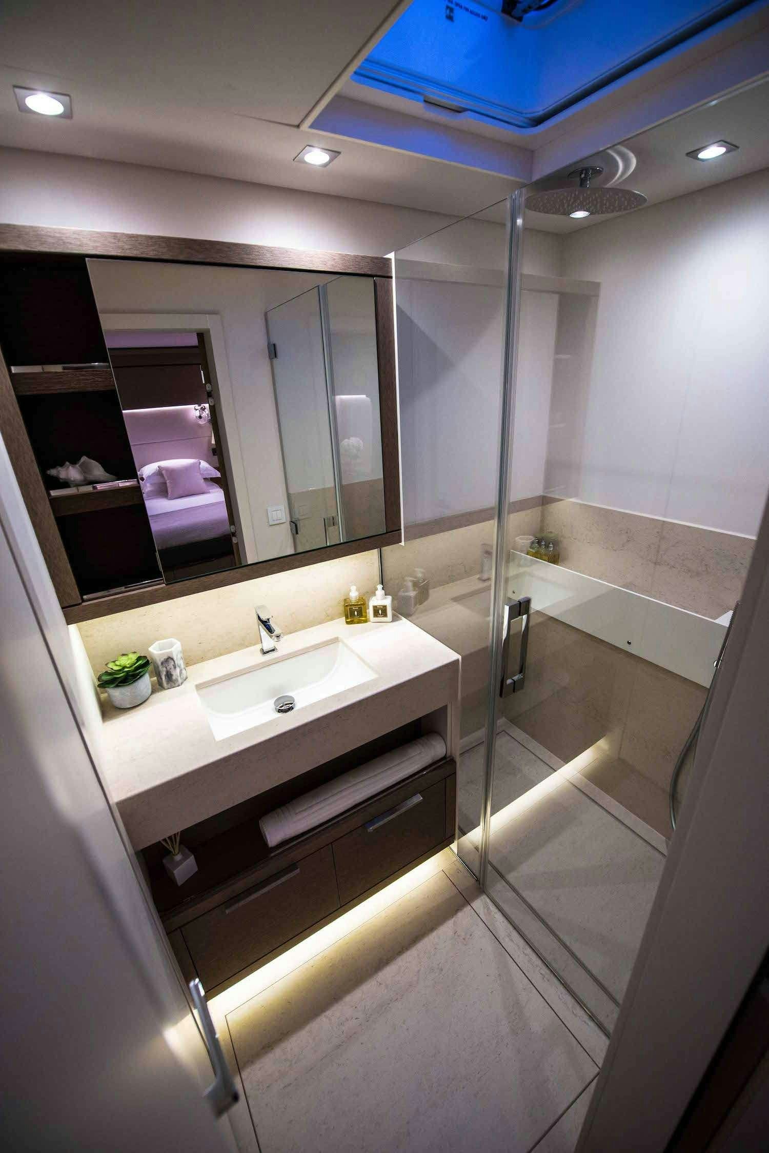 a bathroom with a shower and sink aboard JOY Yacht for Charter