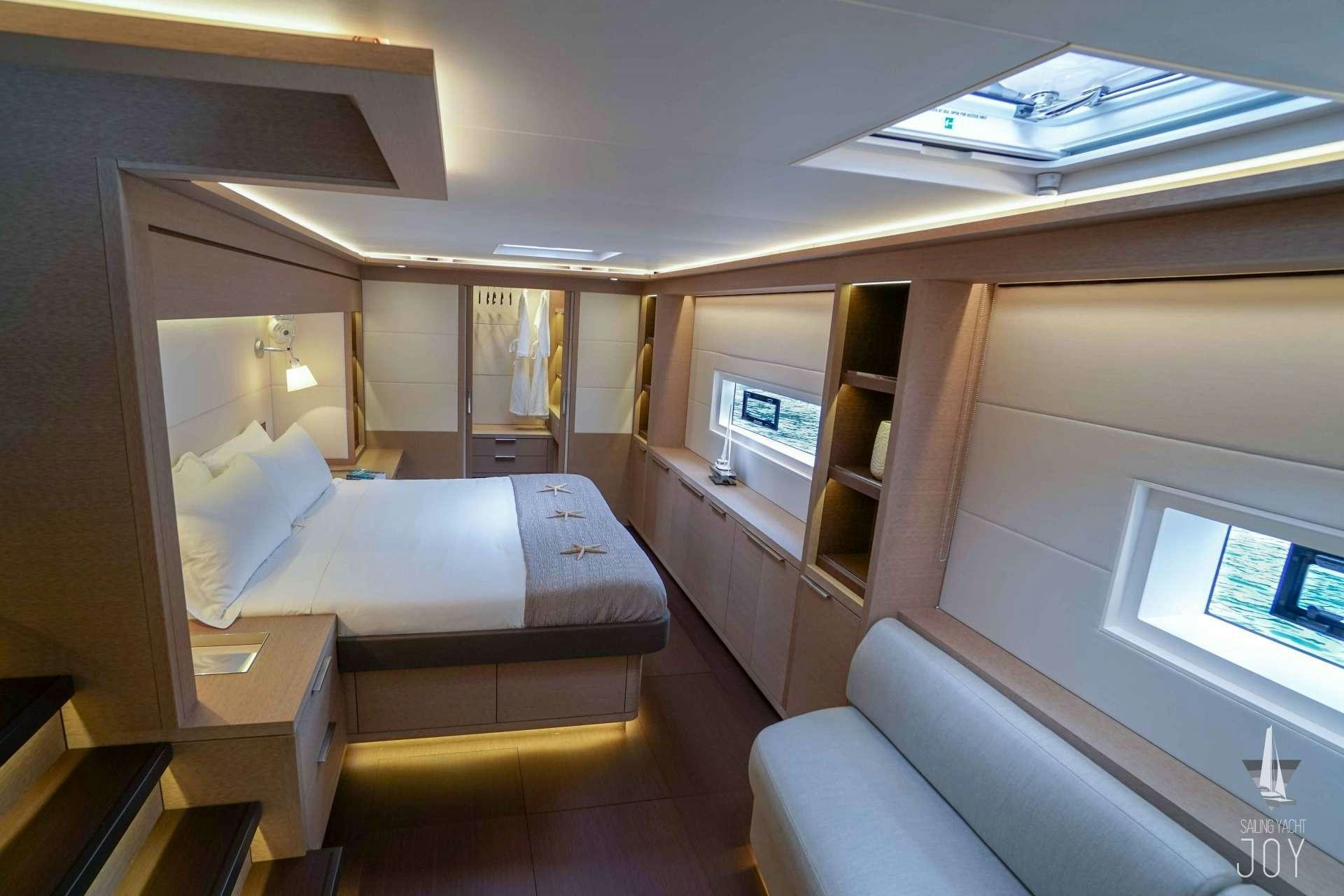 a room with a bed and a desk aboard JOY Yacht for Charter