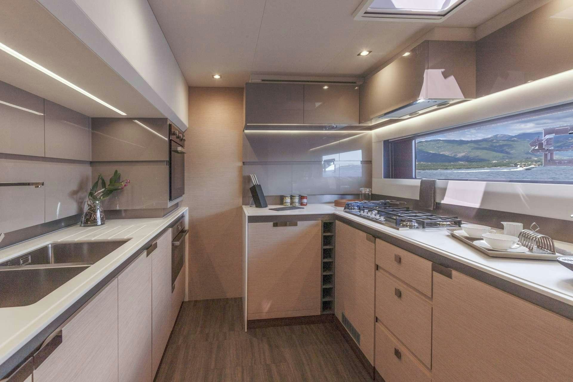 a kitchen with a large window aboard AETHER Yacht for Charter