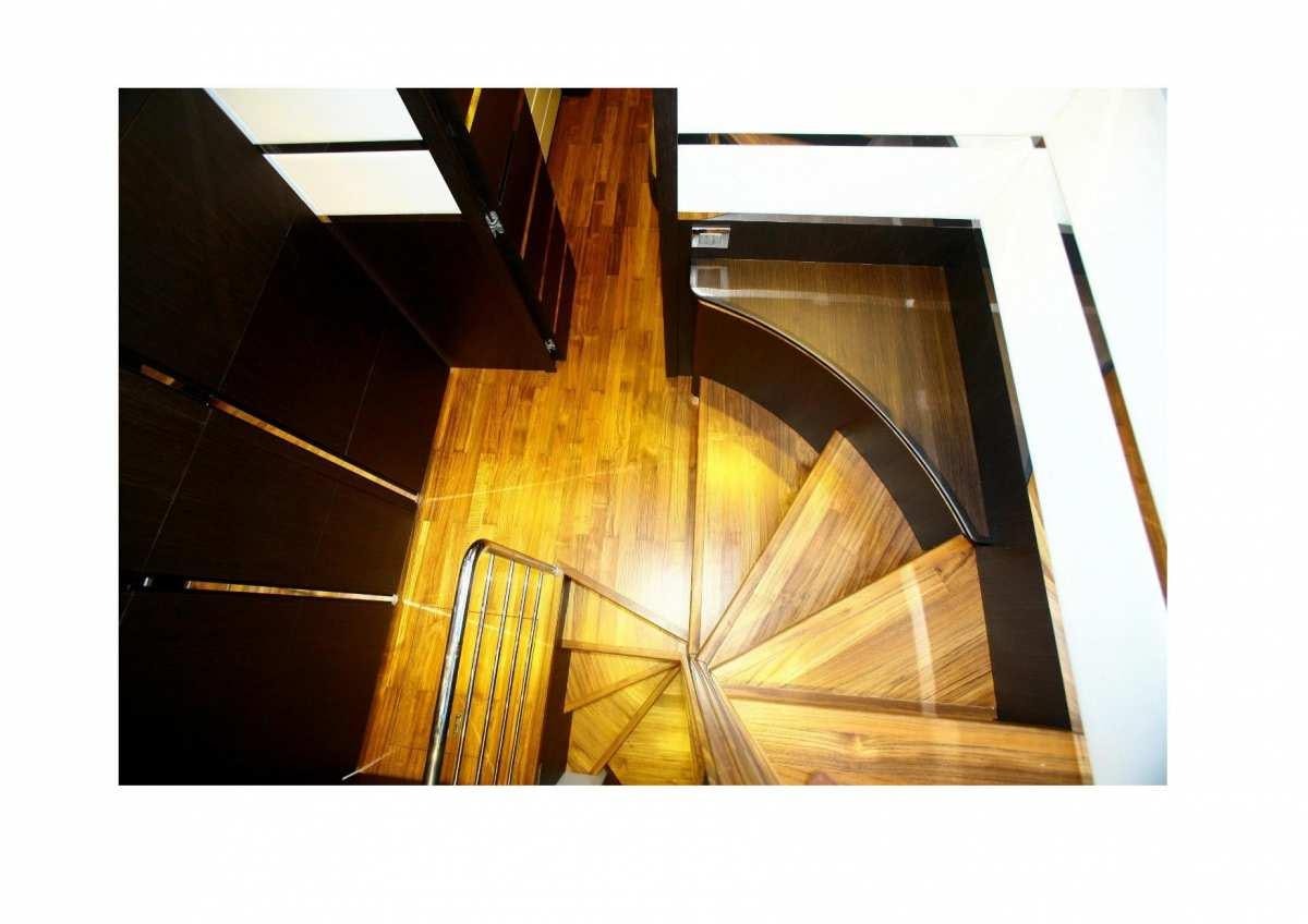 a wooden staircase with a glass case aboard DADDA Yacht for Charter