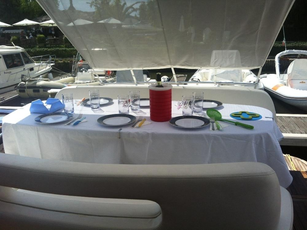 a table with plates and glasses on it aboard DADDA Yacht for Charter