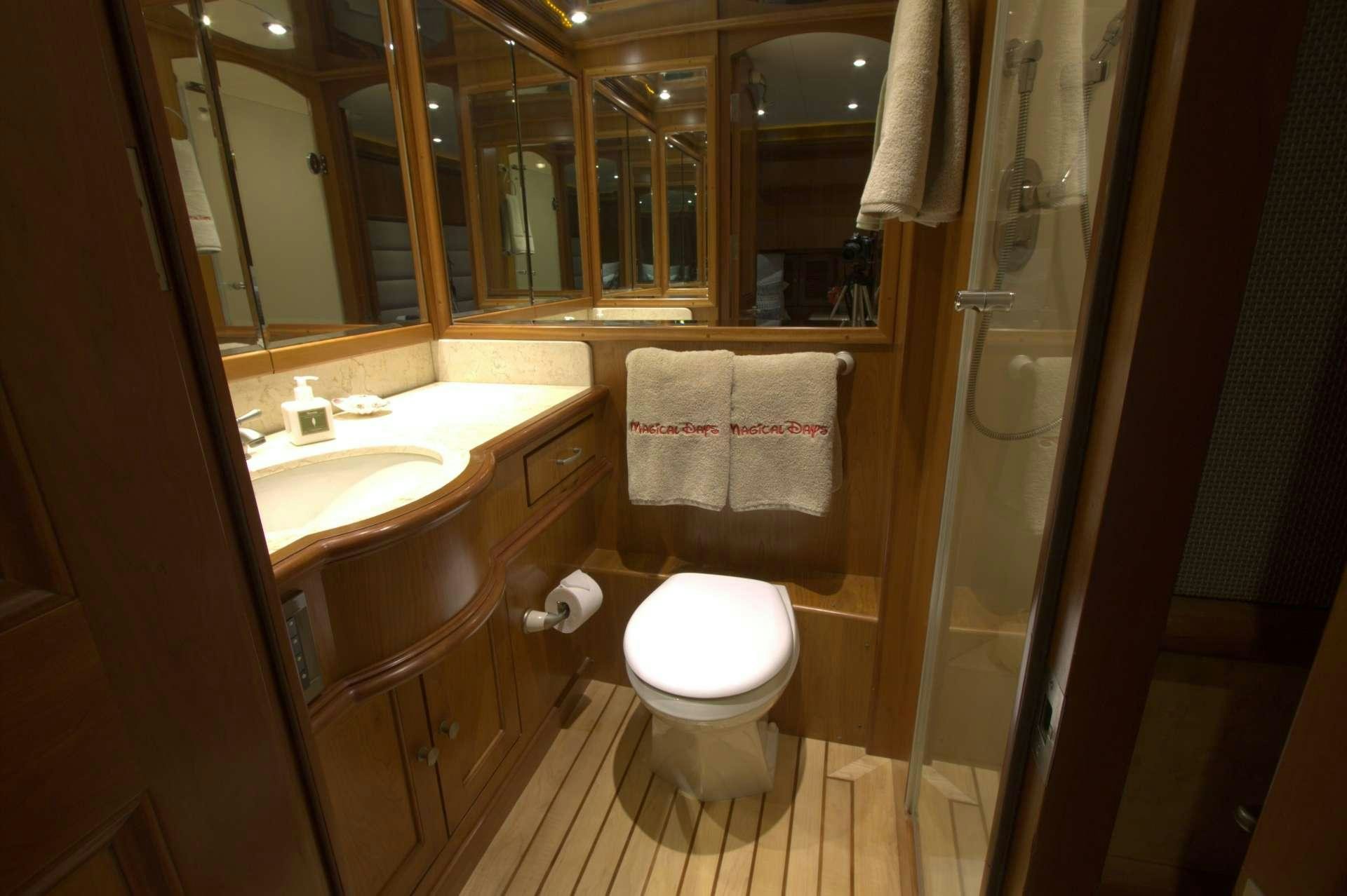 a bathroom with a sink toilet and a mirror aboard MAGICAL DAYS Yacht for Charter