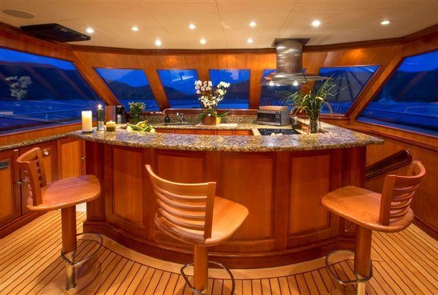 a kitchen with a bar and stools aboard MAGICAL DAYS Yacht for Charter