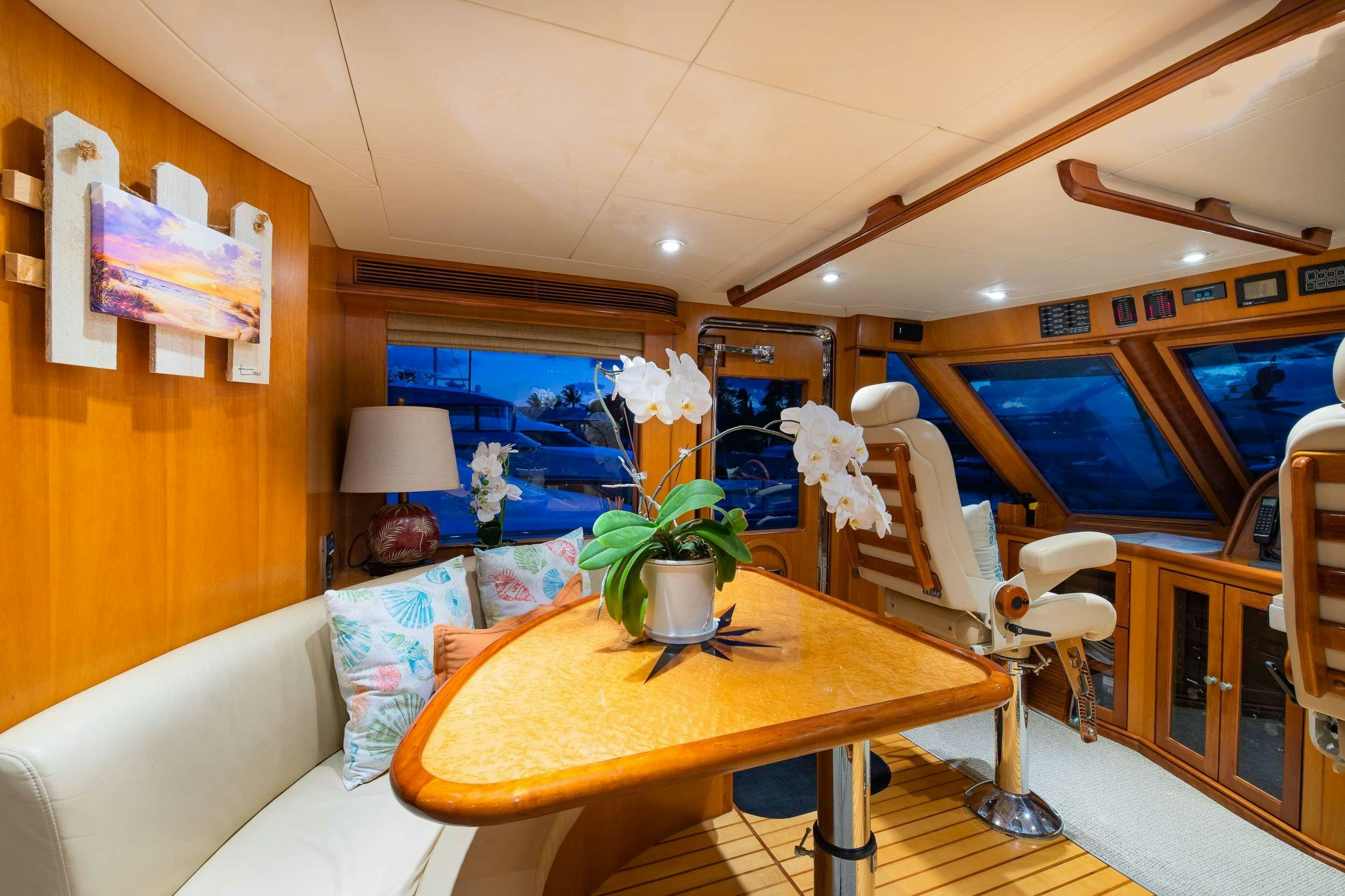 a living room with a table and chairs aboard MAGICAL DAYS Yacht for Charter