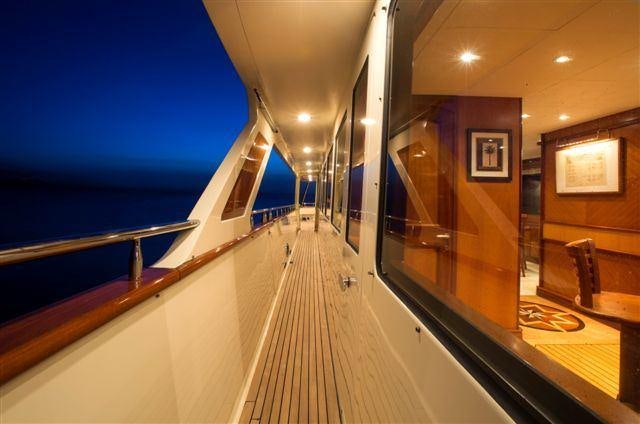 a long hallway with a railing aboard MAGICAL DAYS Yacht for Charter