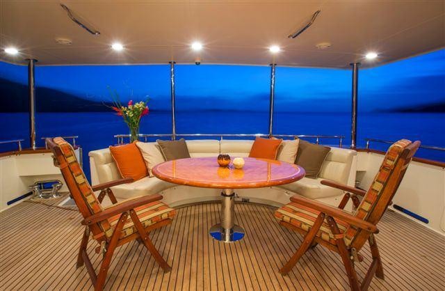 a room with a table and chairs aboard MAGICAL DAYS Yacht for Charter