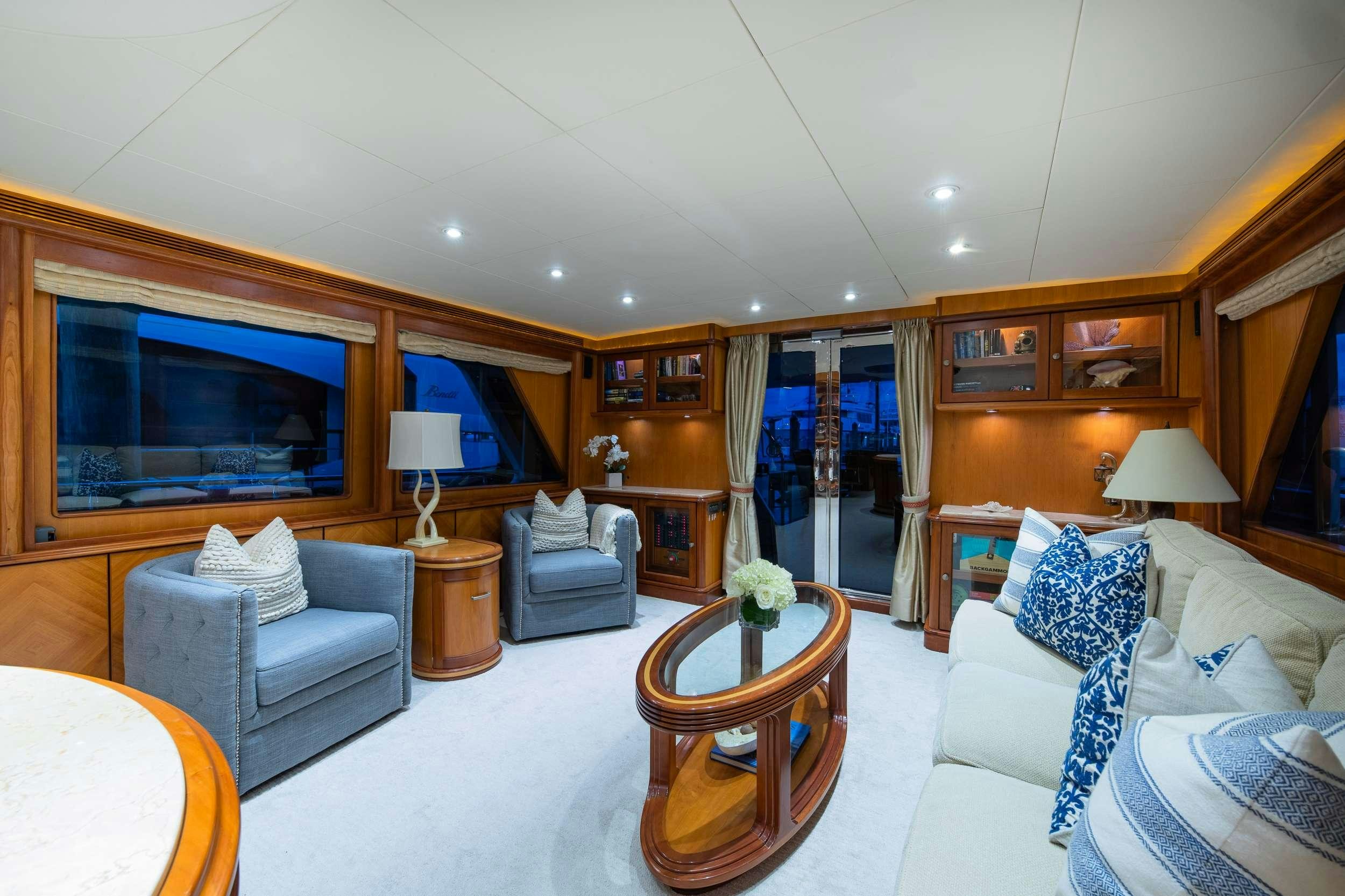 a living room with a large television and a table aboard MAGICAL DAYS Yacht for Charter