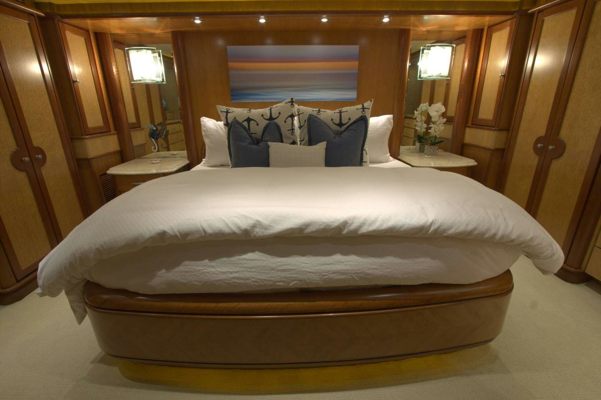 a bed with a white sheet aboard MAGICAL DAYS Yacht for Charter