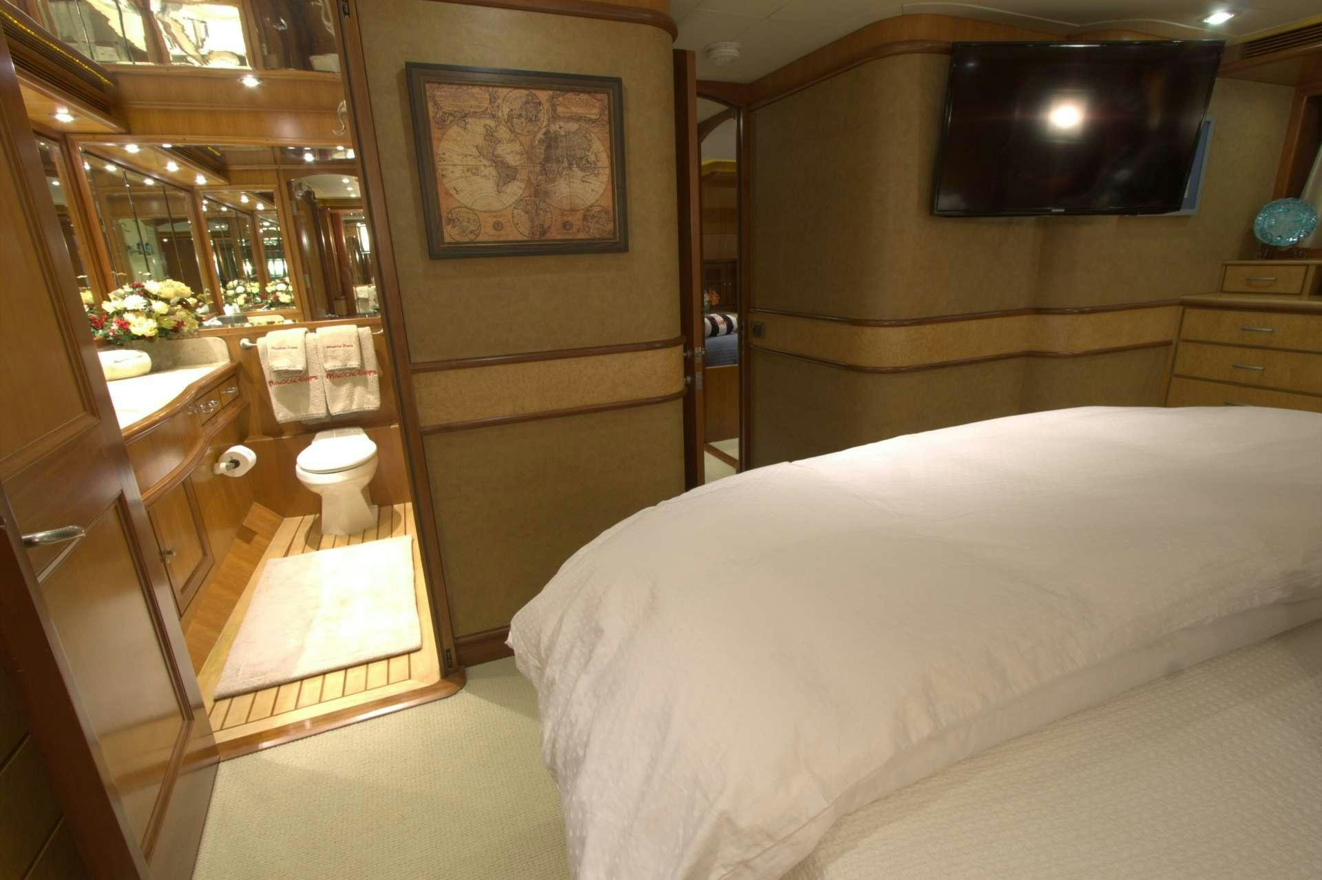 a room with a bed and a mirror aboard MAGICAL DAYS Yacht for Charter