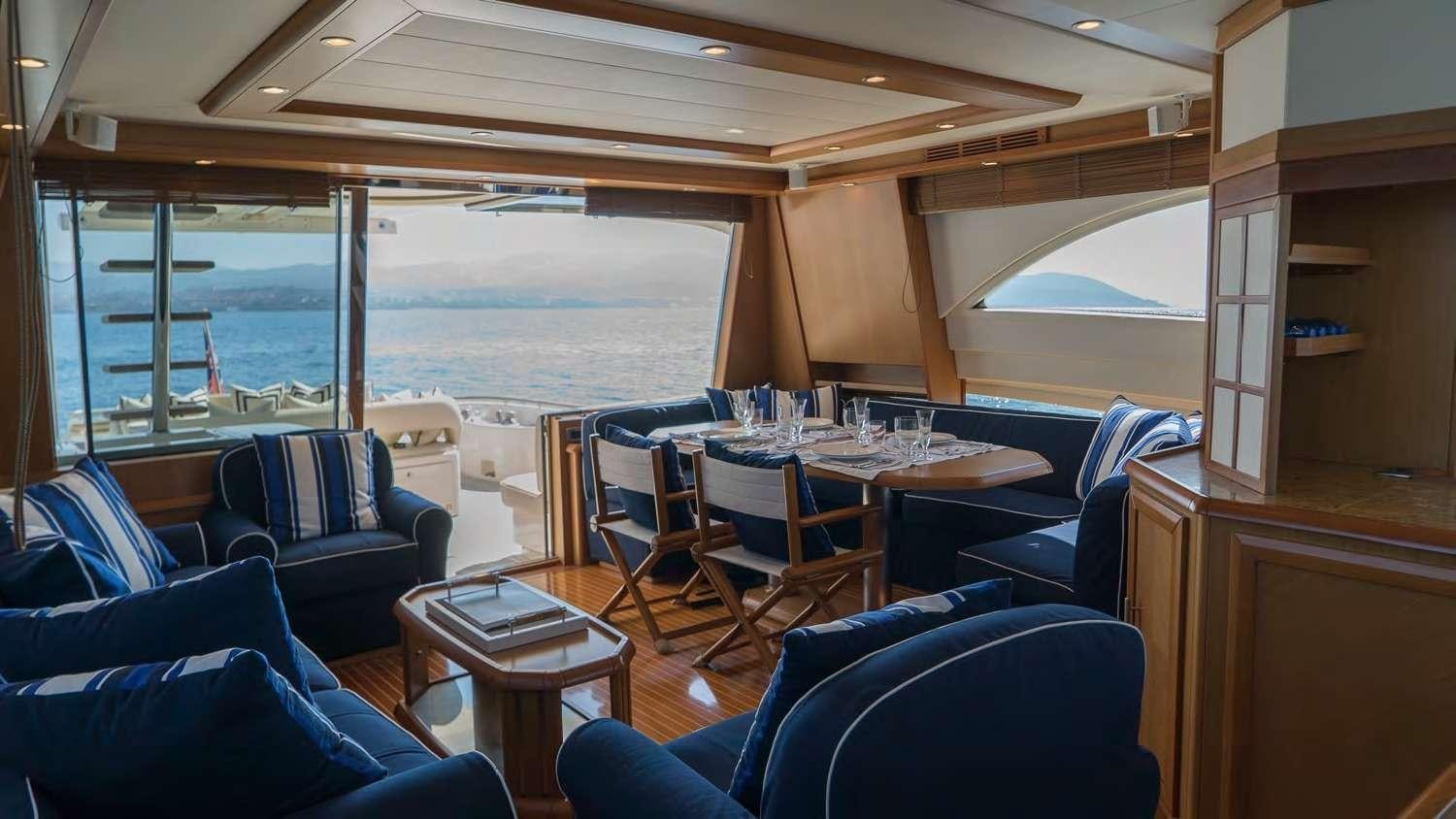 a room with a table and chairs aboard LUMIERE Yacht for Charter