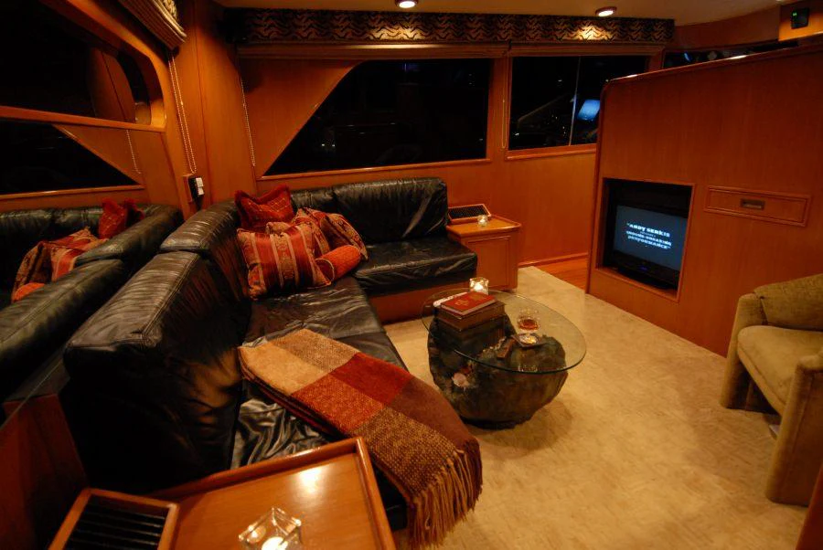 a living room with a couch and a tv aboard KALEEN Yacht for Charter