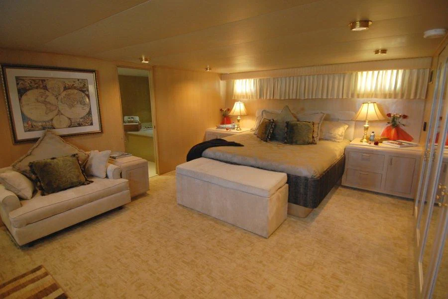 a large bedroom with a bed and a couch aboard KALEEN Yacht for Charter