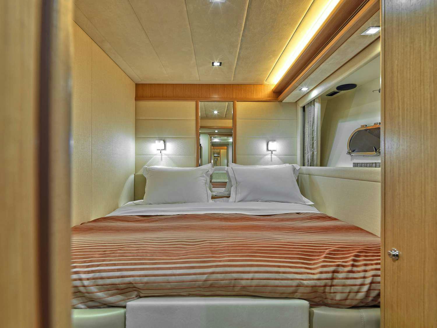 a bed with a pink sheet aboard JULIE M Yacht for Charter